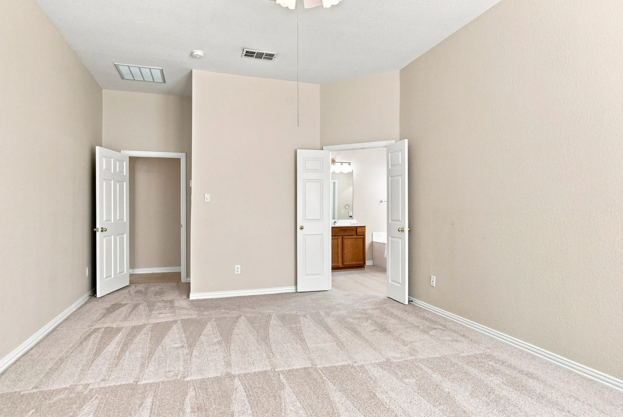 Carpeted flooring throughout, vaulted ceiling, and white trim