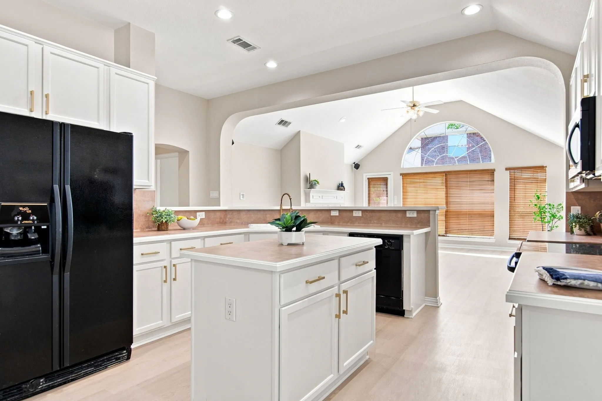 White cabinetry with gold-finish hardware, a central island, and recessed​​‌​​​​‌​​‌‌​‌‌​​​‌‌​‌​‌​‌​​​‌​​ lighting