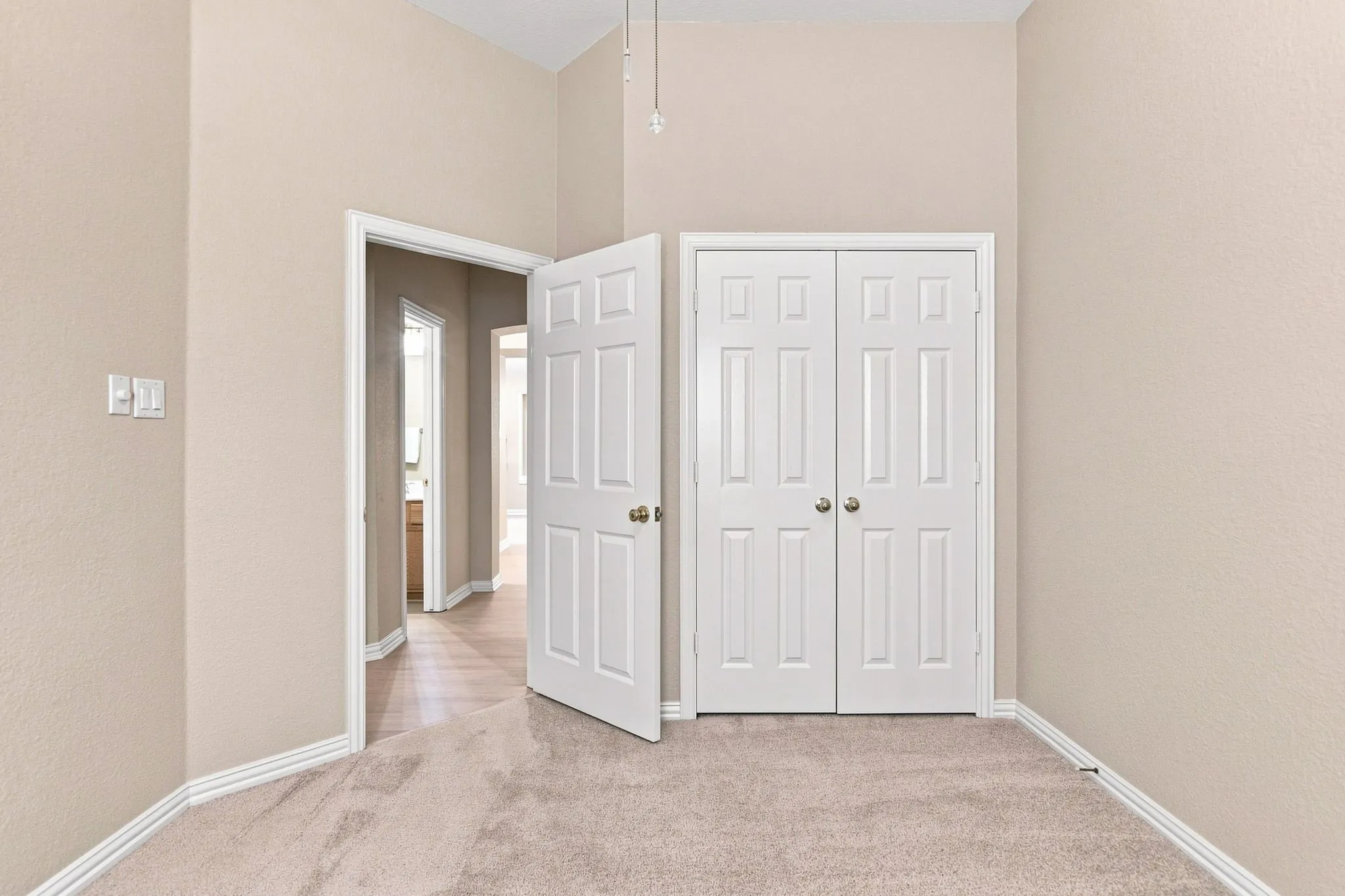 Neutral-toned walls with contrasting white trim and doors