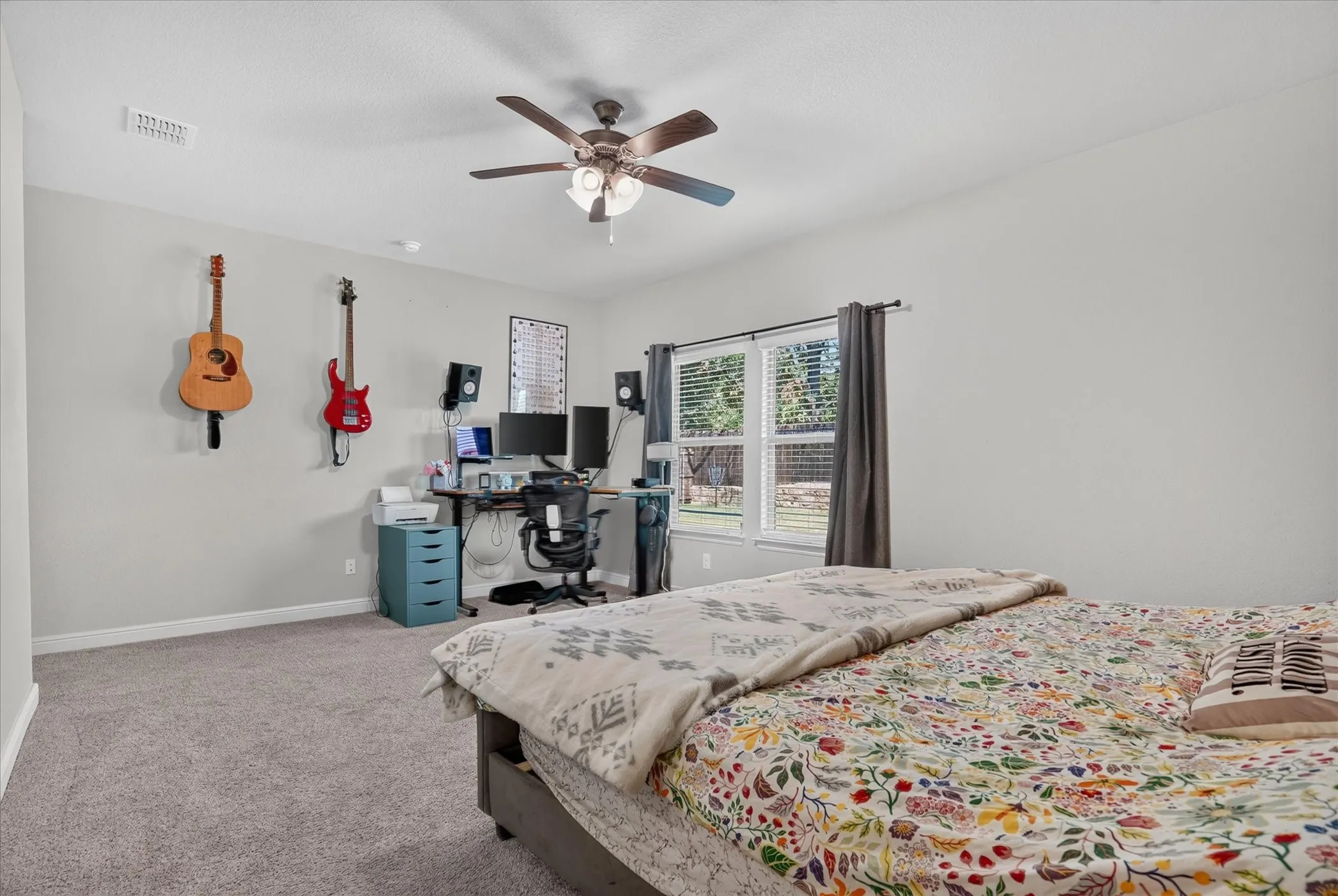 Recessed ceiling fan with integrated lighting, window with blinds and drapes, and neutral wall tones