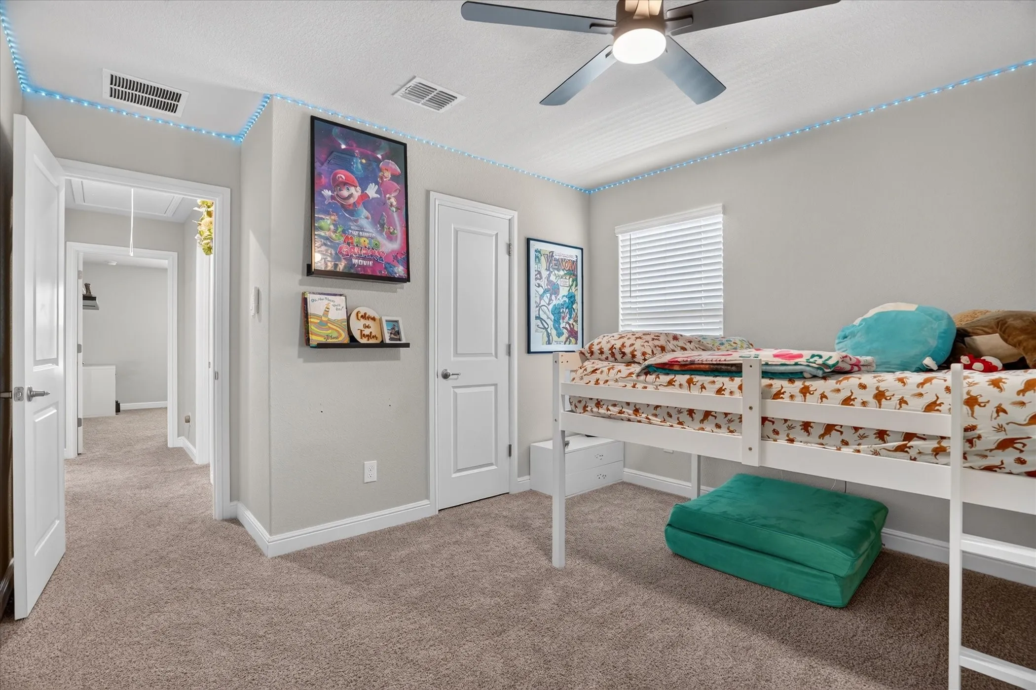 Carpeted room with a ceiling fan, white trim, and a window with blinds