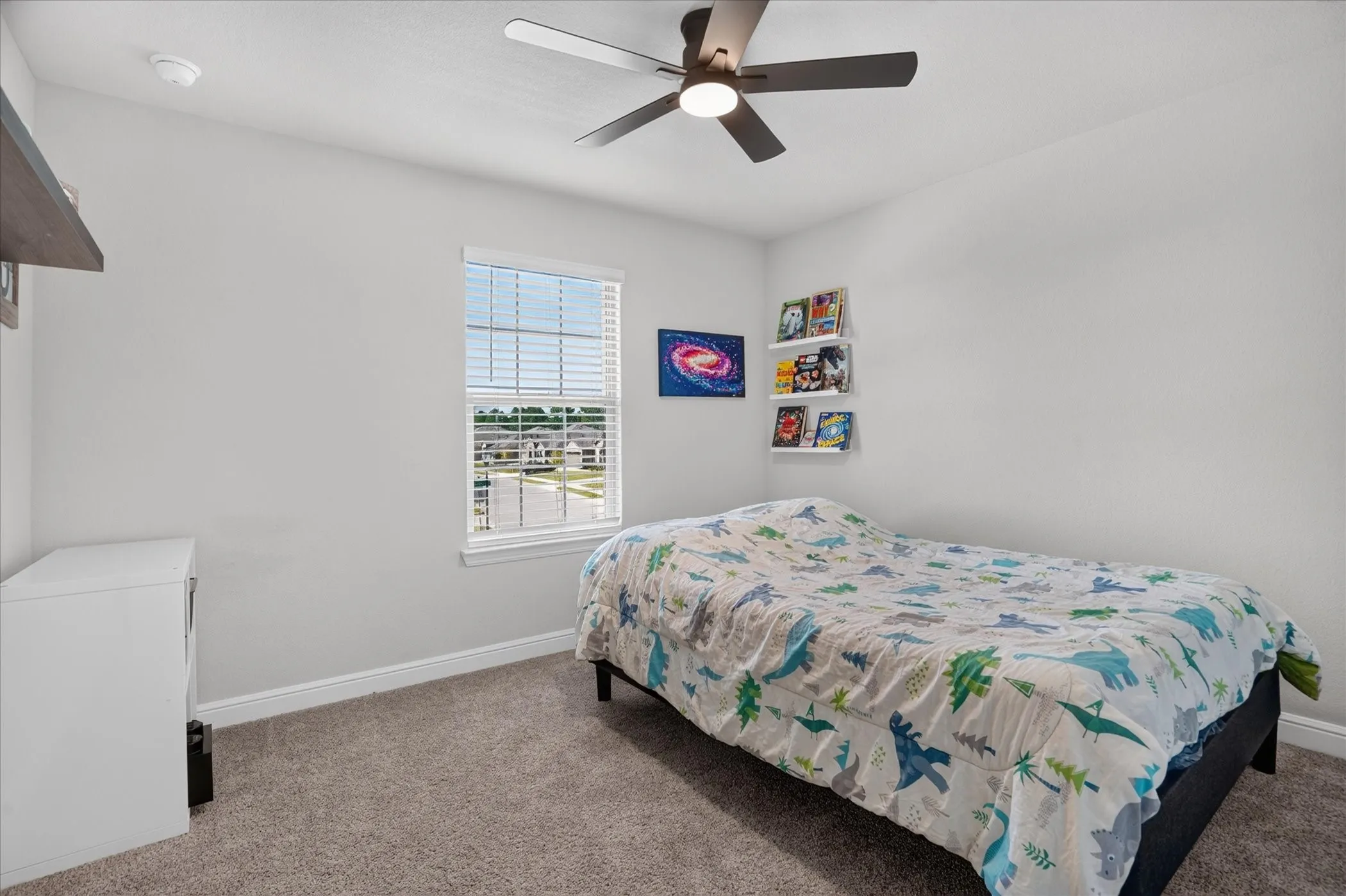 Recessed lighting, ceiling fan, window with blinds, wall-mounted shelving, and carpeted flooring