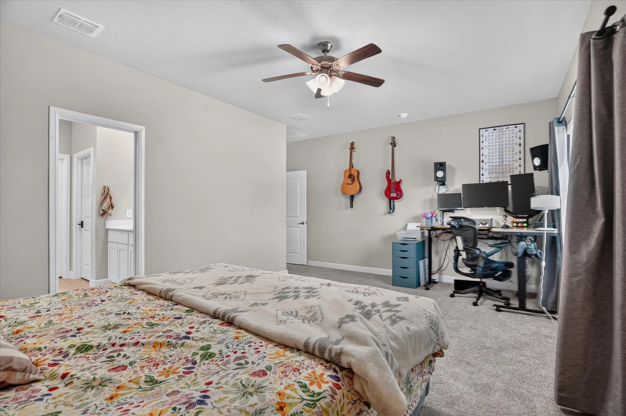 Light gray walls with carpeting, and a ceiling fan with integrated lighting