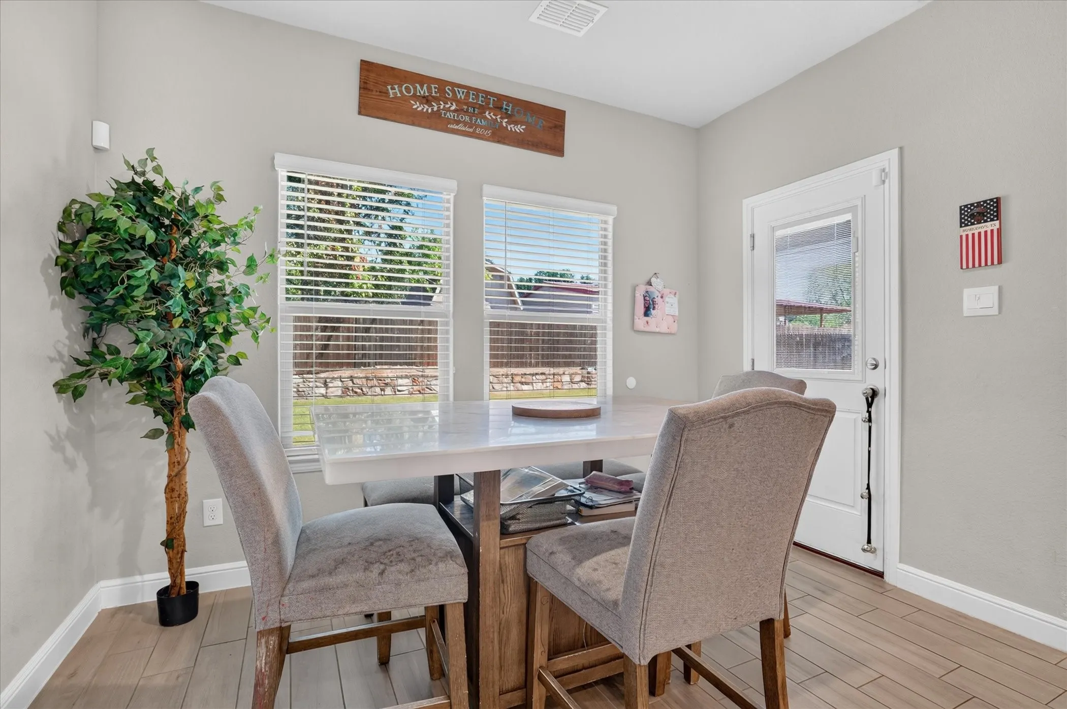 Wood-finish flooring throughout, light gray wall paint, and white trim