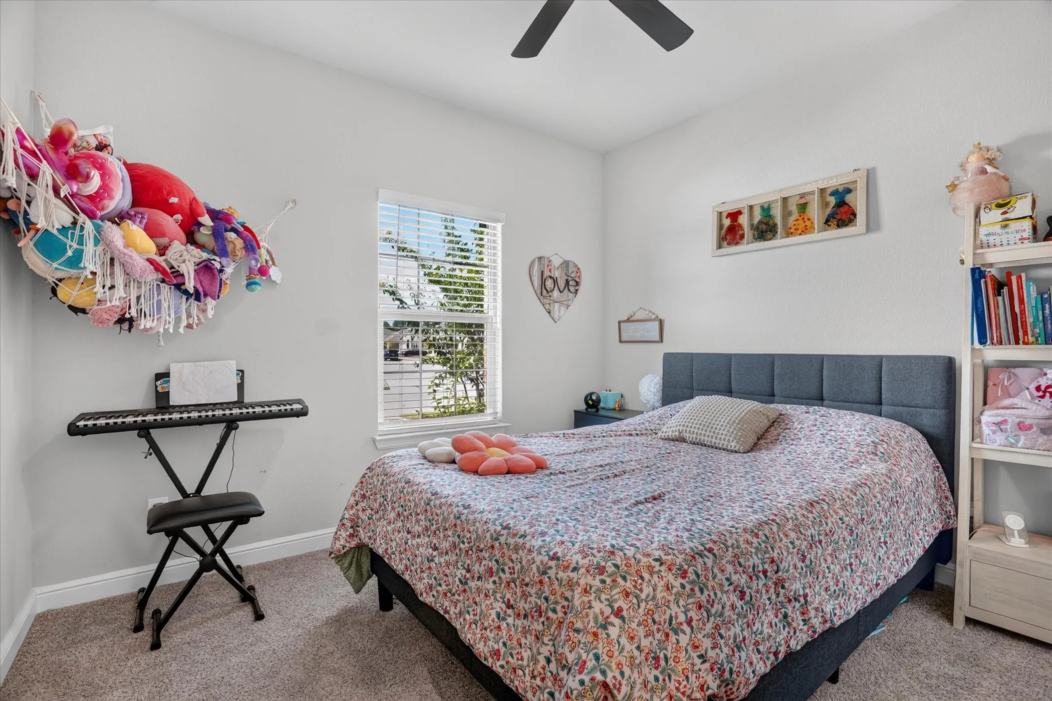 Carpeted flooring, a window with horizontal blinds, and a built-in ceiling fan with lighting