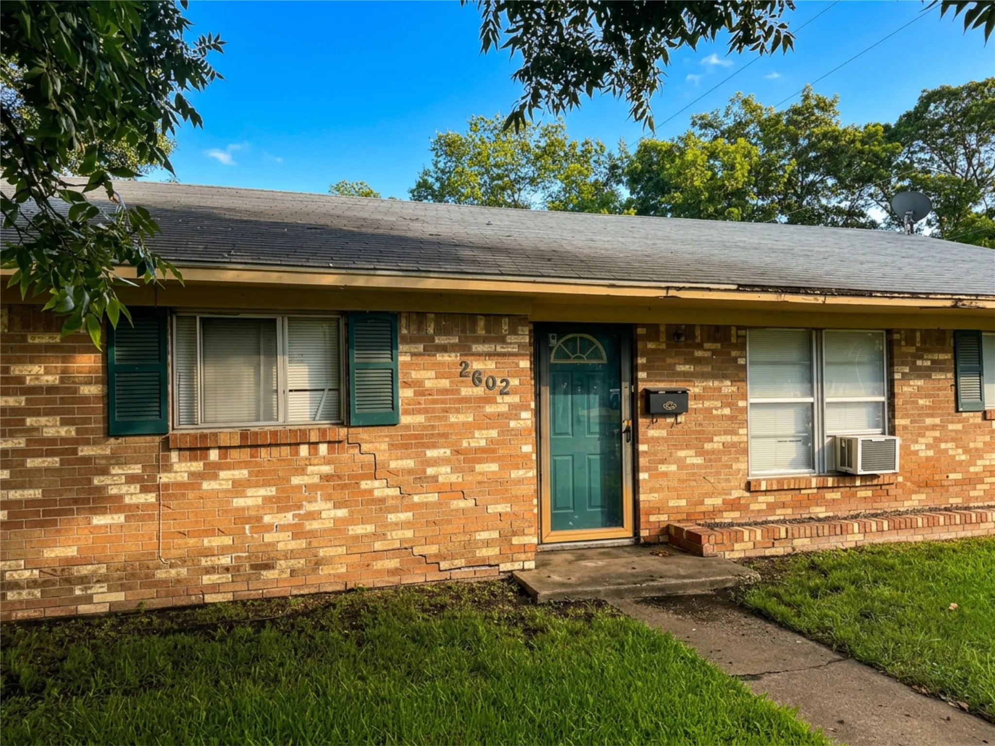 Brick exterior with green entry door