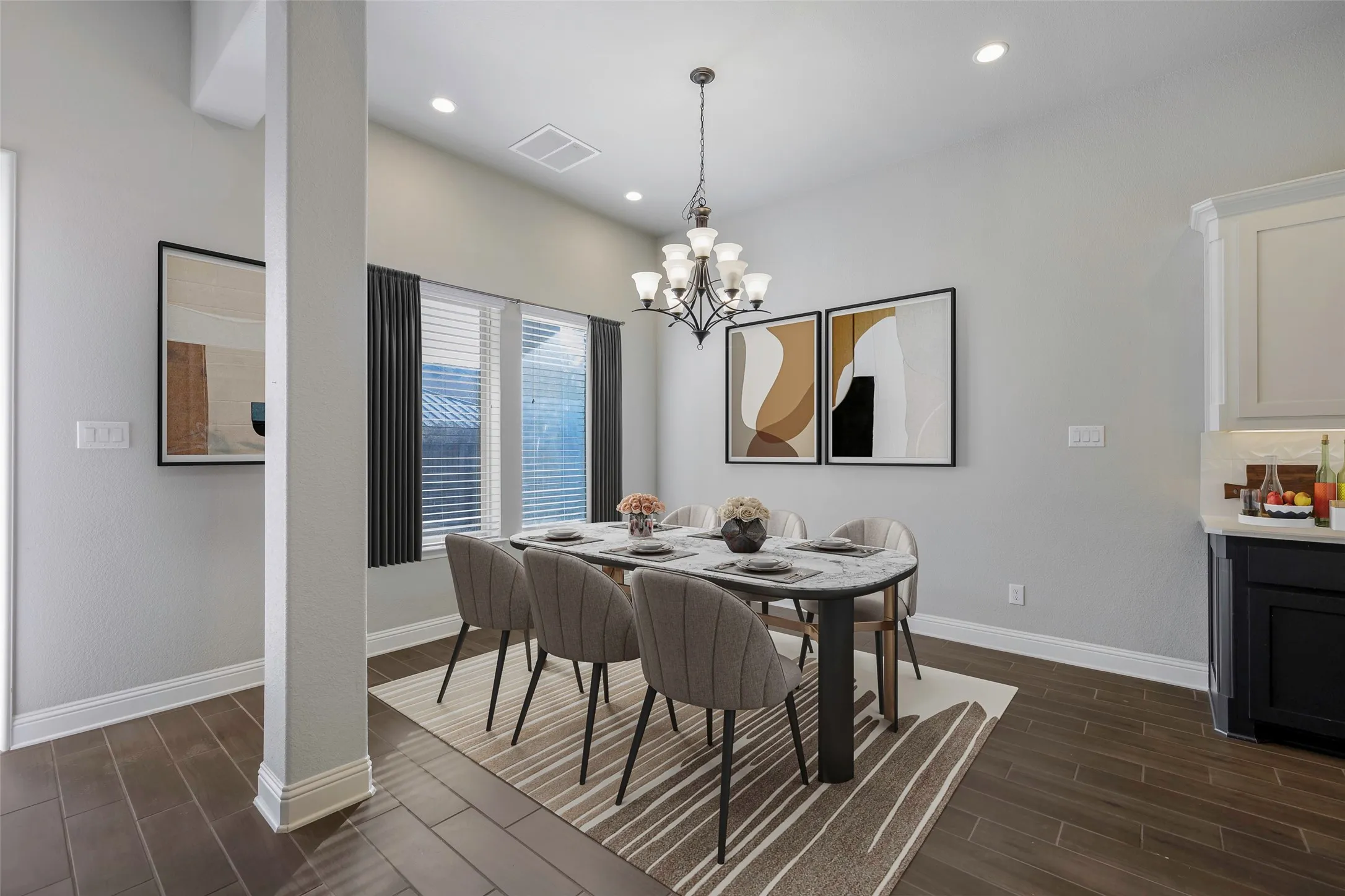 Dining area featuring wood-finish flooring, recessed lighting, and a chandelier