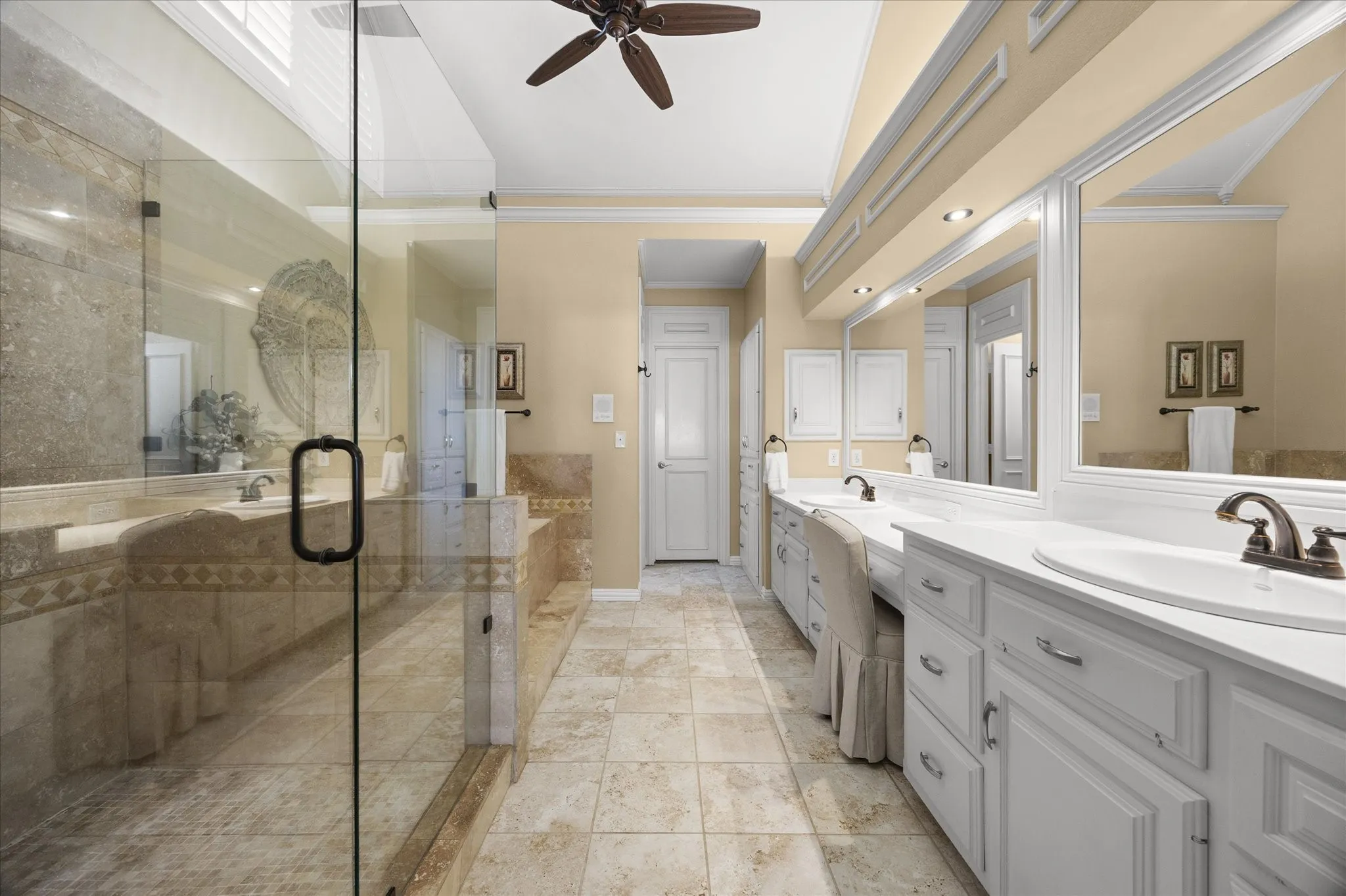 Spa style master bath includes his and her vanities with make up vanity.