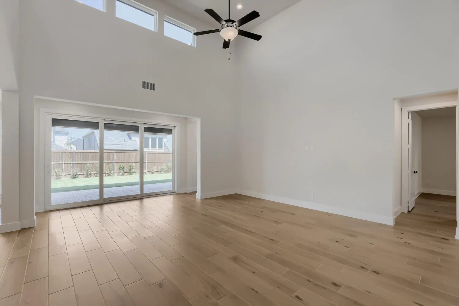 Large family room with vaulted ceilings and transom windows