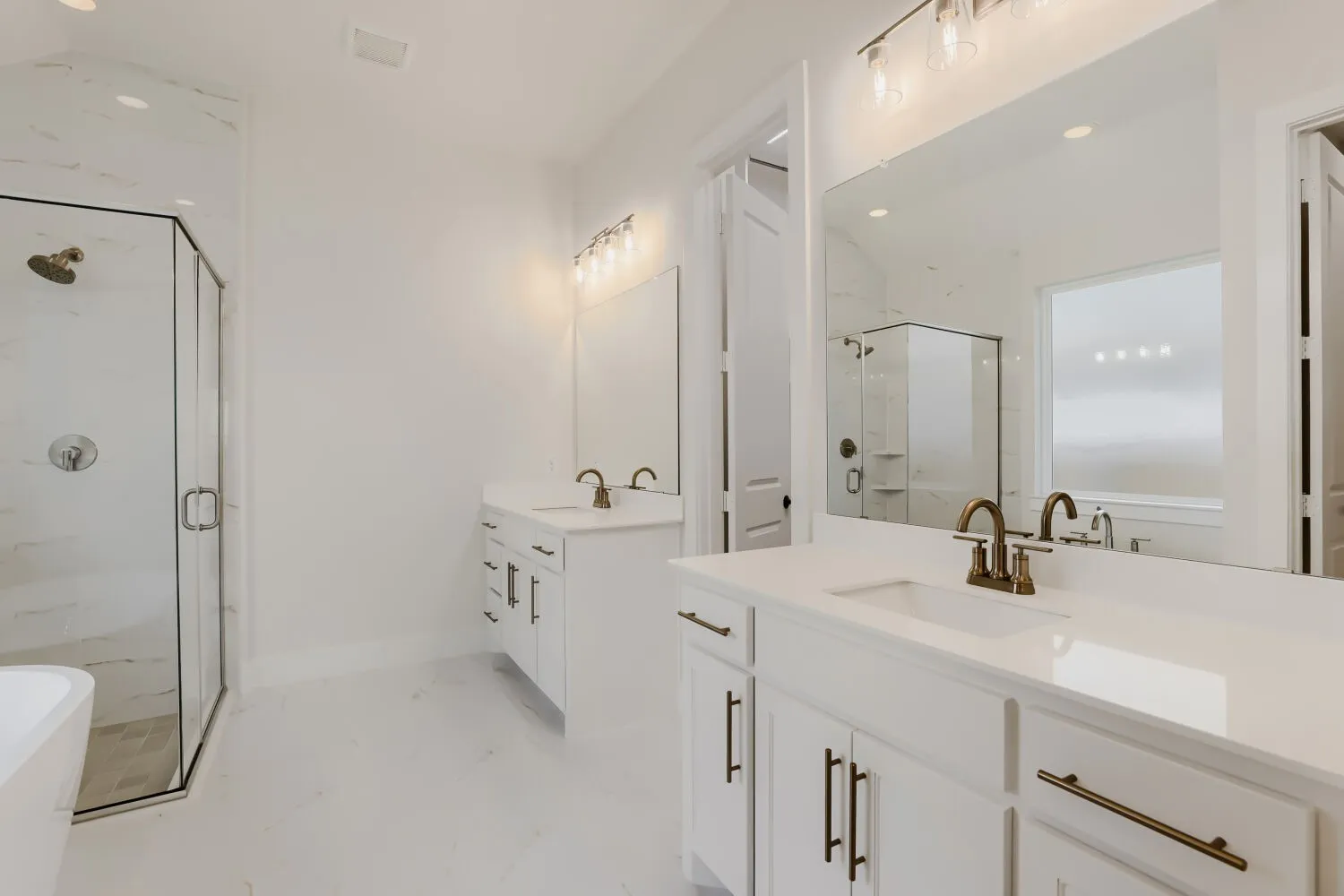 Dual vanities with white cabinetry and quartz countertops