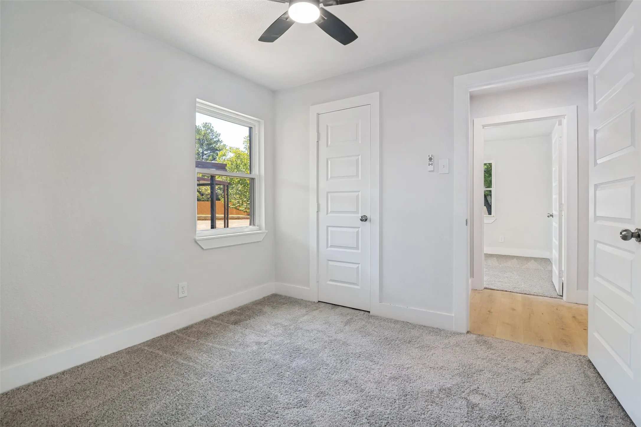 Recessed lighting, ceiling fan, wood-finish flooring, white panel doors, and neutral wall tones