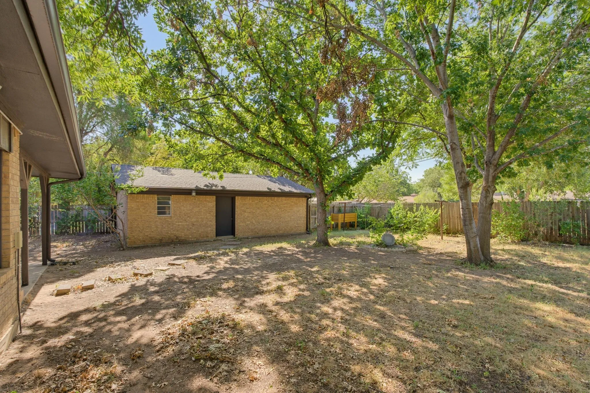 Detached garage with workshop area or extra storage space.