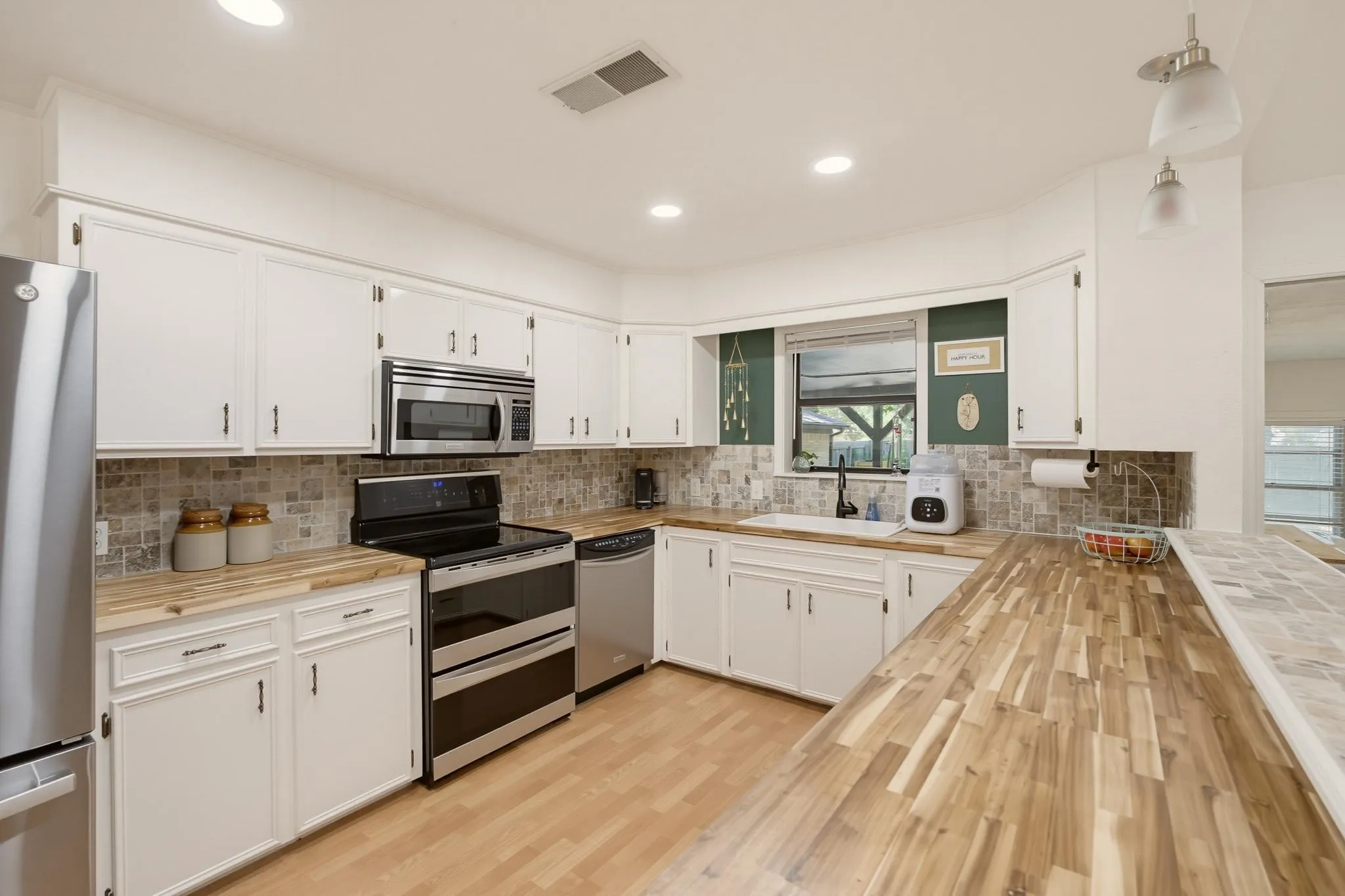 Kitchen with butcher block countertops, spacious counter space, and double oven range.