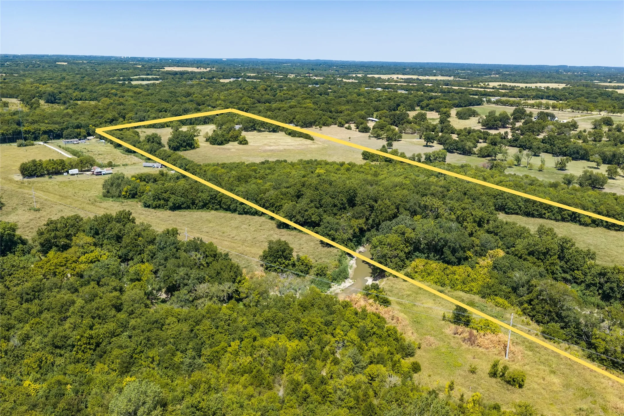 Rich in natural beauty! Choctaw Creek meanders through the eastern side of the wooded acreage while terraced pastureland and mature Pecan, Oak, and Cottonwood trees create a picturesque landscape.
