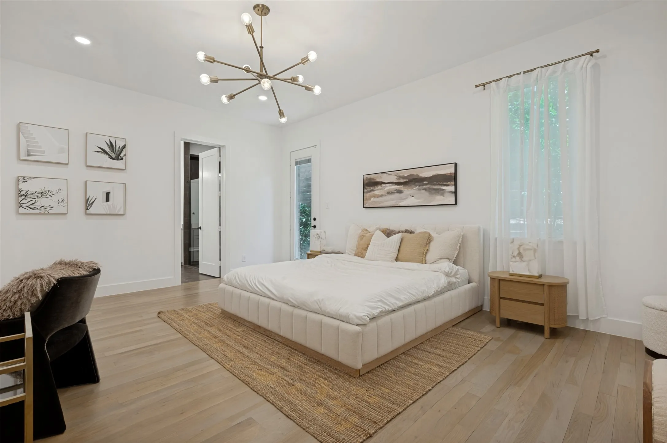 Recessed lighting, light wood-finish flooring, and a modern sputnik chandelier