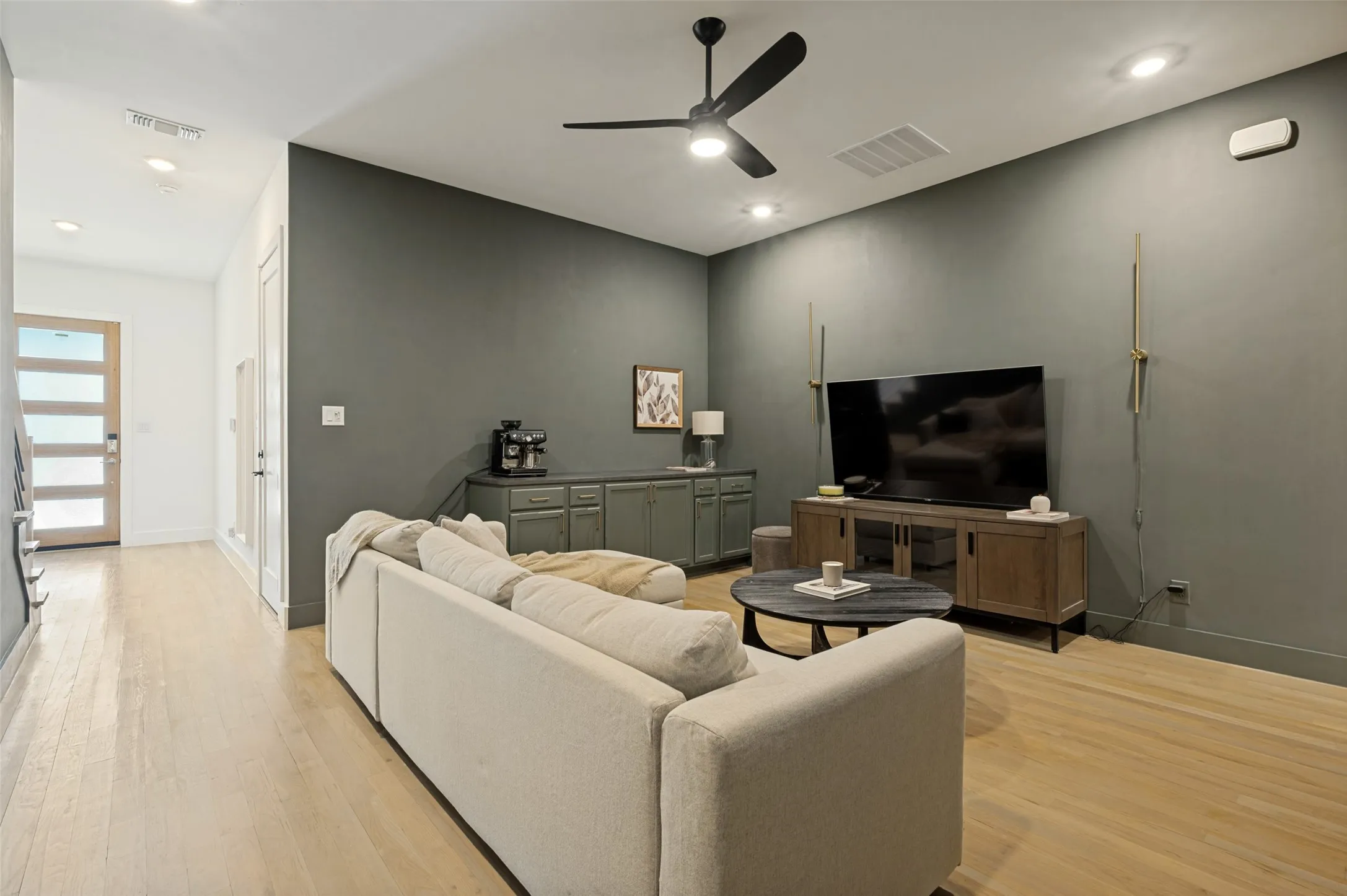 Wood-finish flooring throughout, recessed lighting, and a modern ceiling fan
