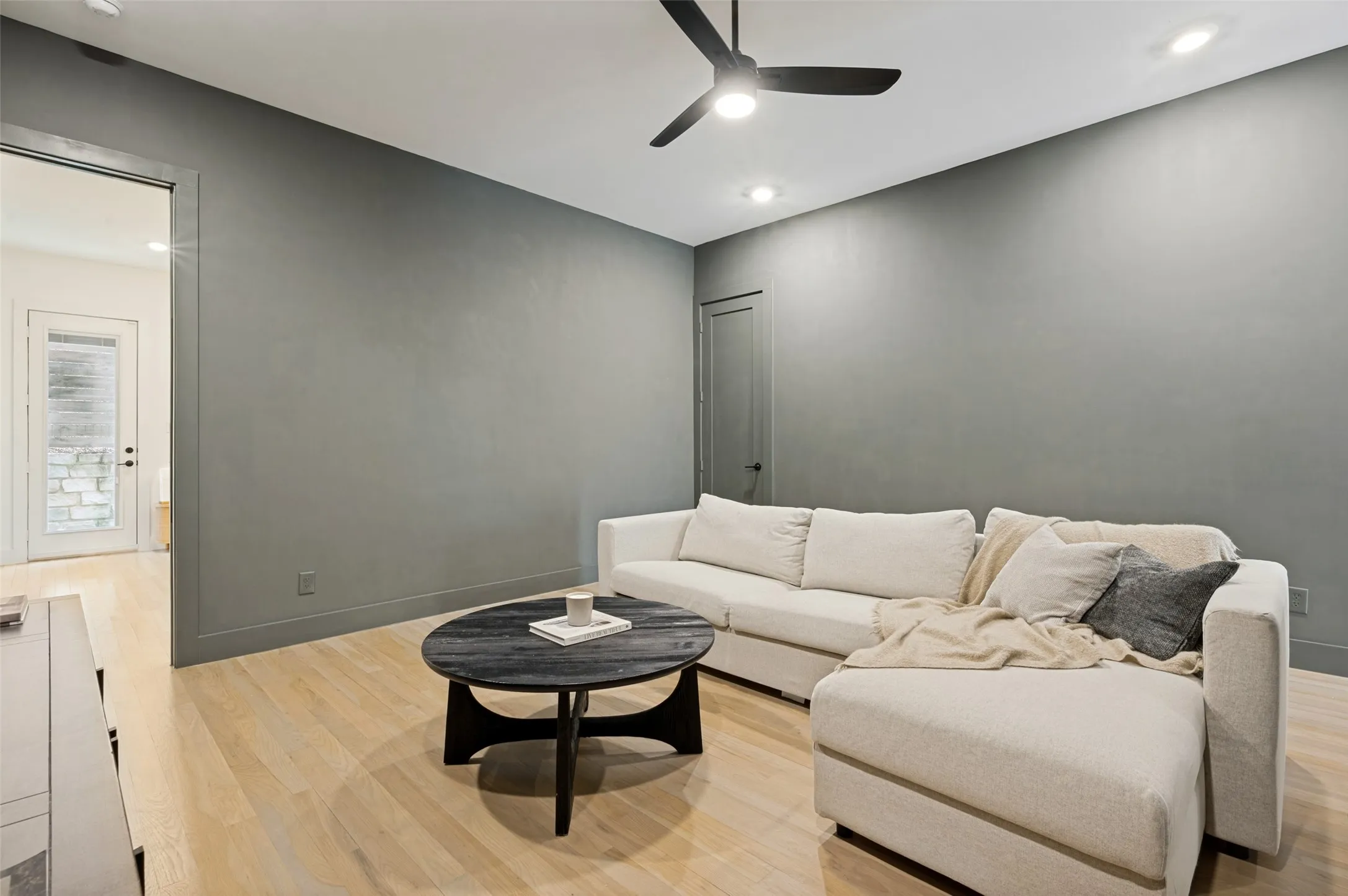 Recessed lighting and ceiling fan, wood-finish flooring, and a door with a frosted glass panel