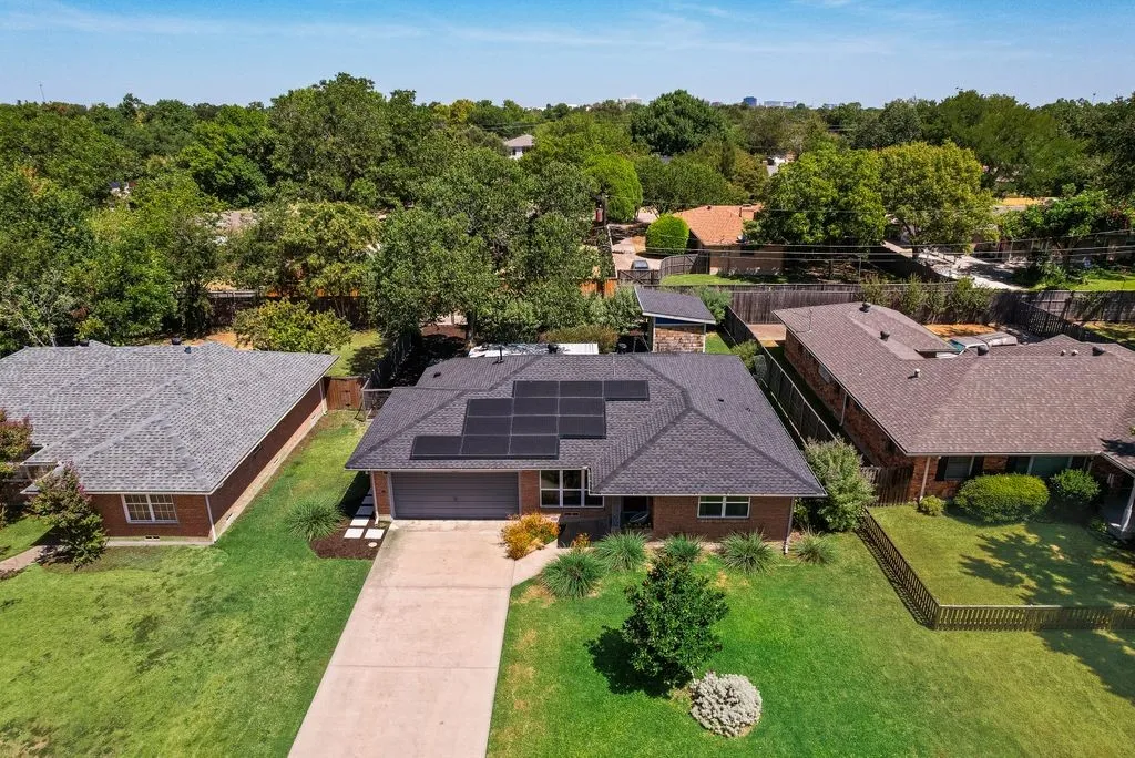 Aerial view. Solar panels are owned.