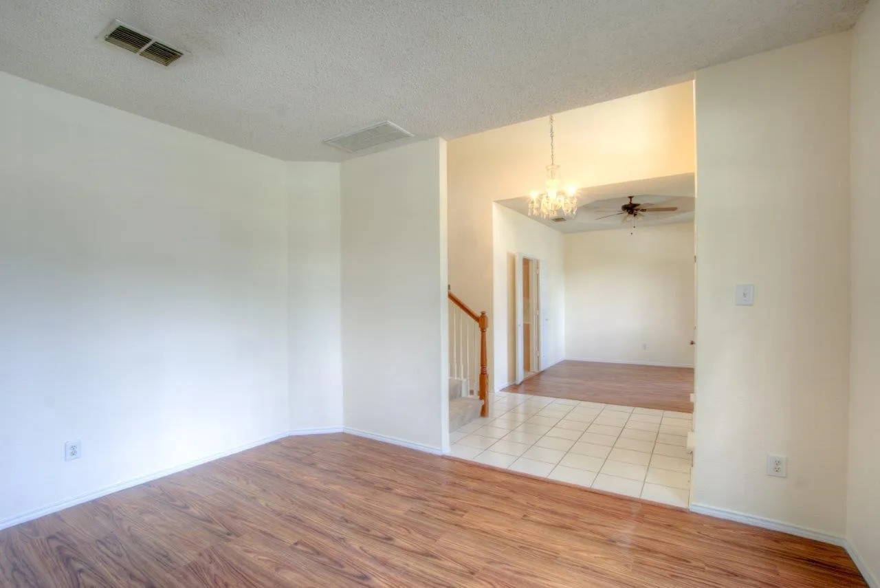 Wood-finish flooring, white wall paint, and tiled flooring