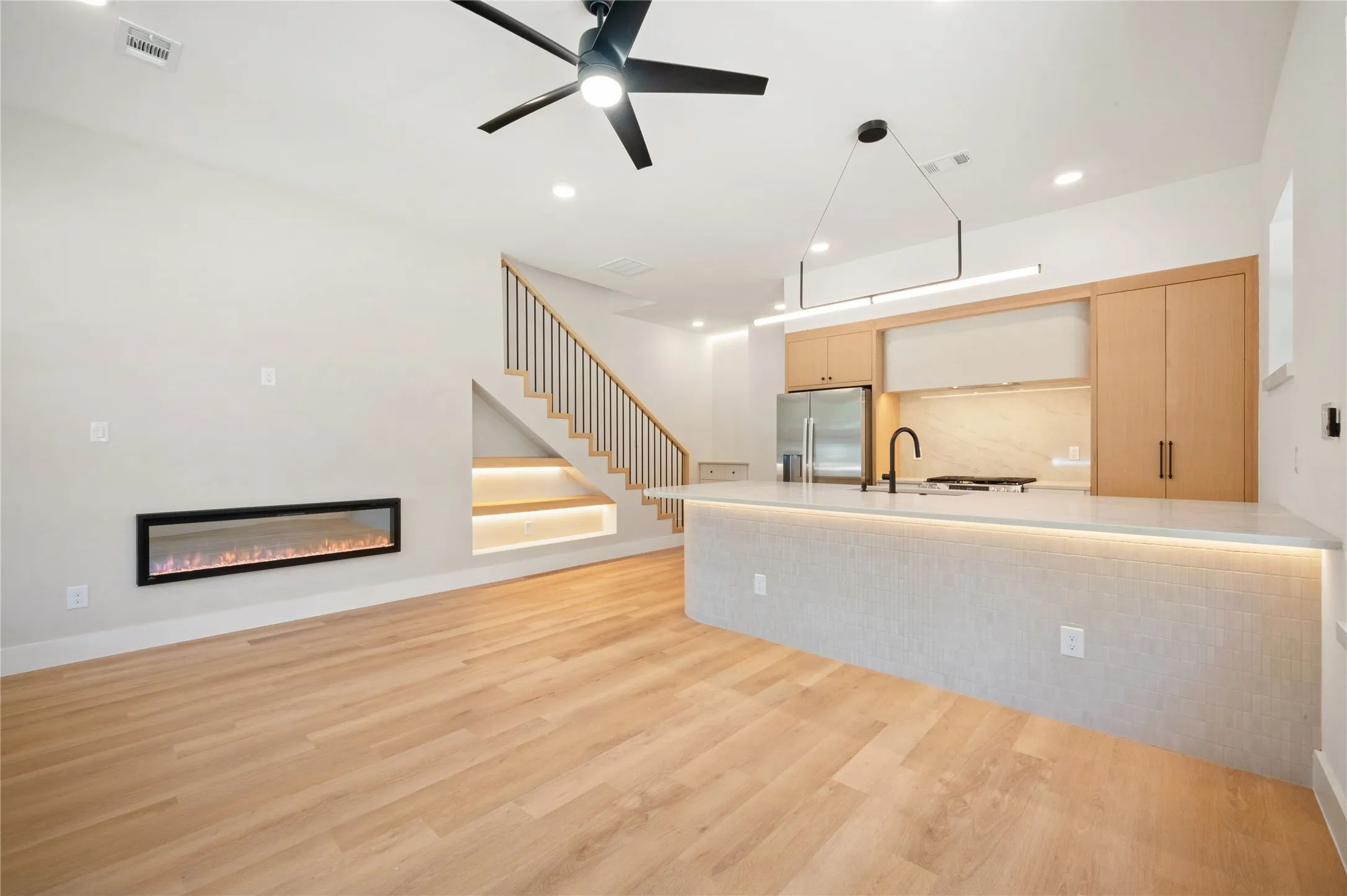 Open floor plan, decorative fireplace and ceiling fans accentuate this home