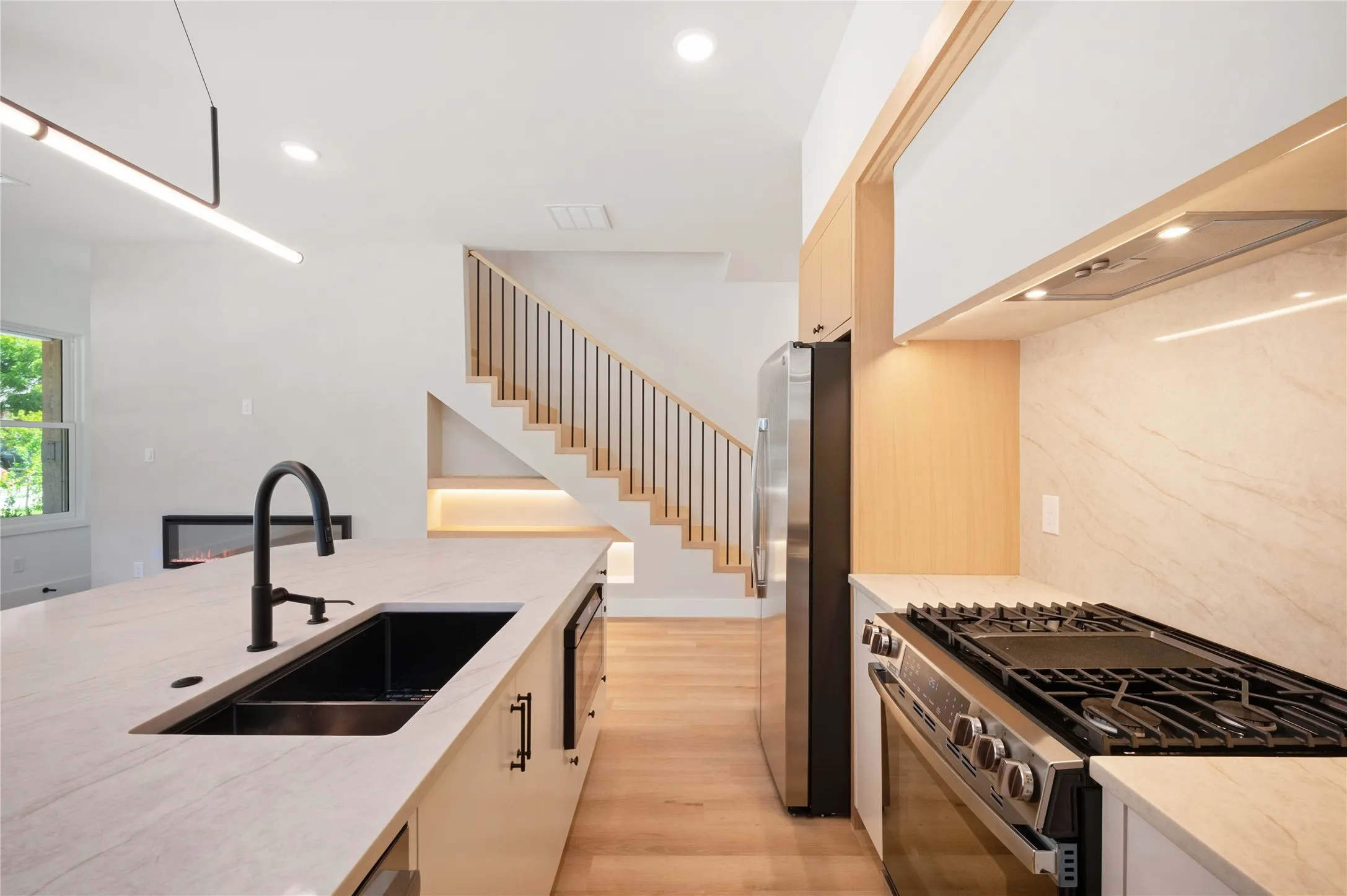 Kitchen island with undermount sink and matte black gooseneck faucet