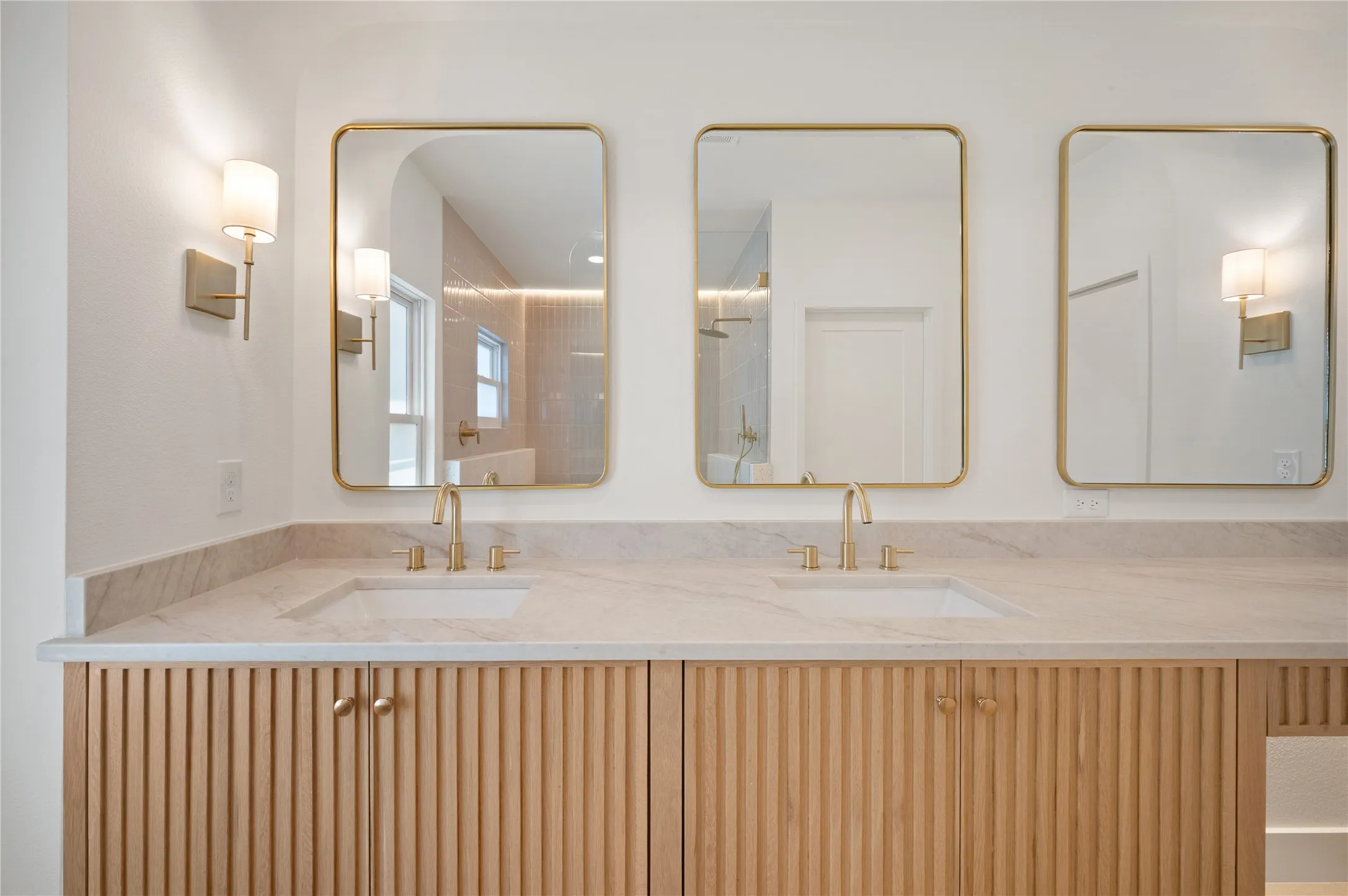 Dual vanity with dual sinks, light-toned countertop, and wood-finish cabinetry