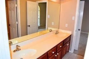 Dual vanity with integrated sinks and chrome fixtures