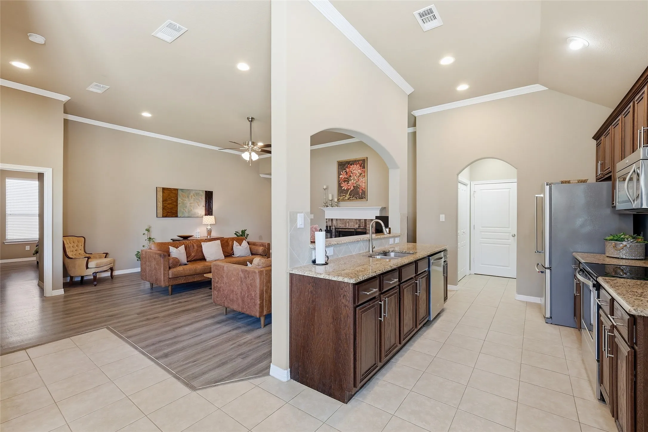 Kitchen featuring granite countertops, wood-finish cabinetry, and stainless steel appliances