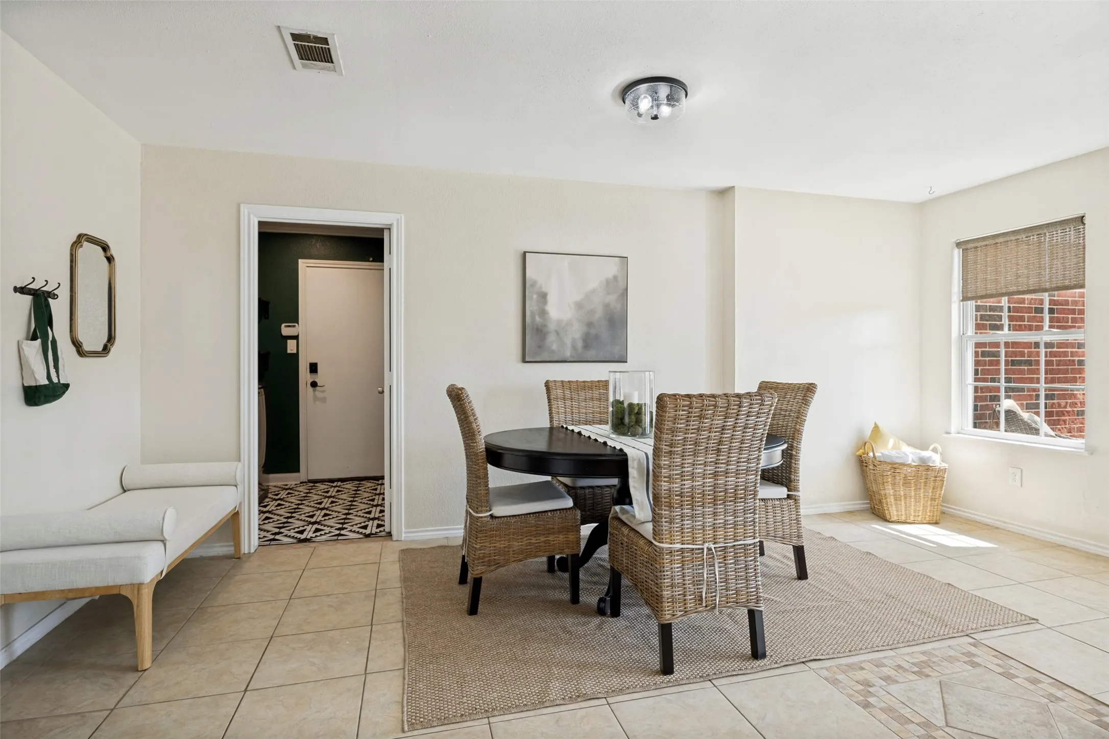 Tiled flooring throughout, recessed lighting fixture, window with privacy blind, and an laundry room with patterned flooring