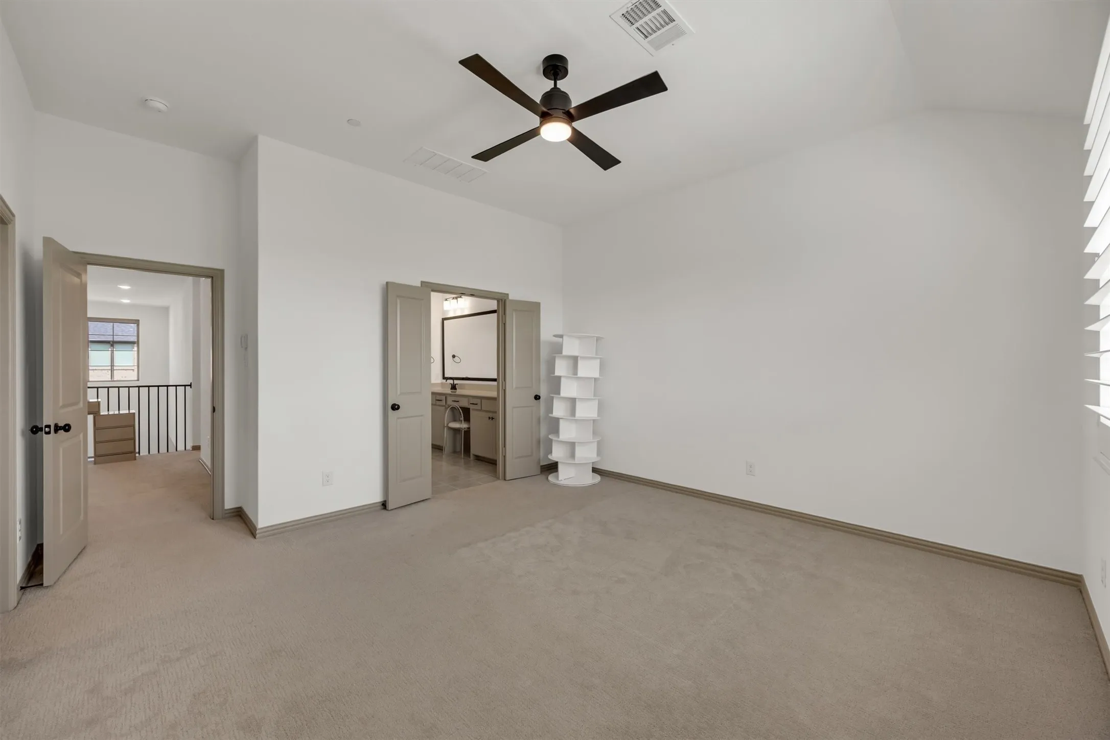 Primary Bedroom
vaulted ceilings, a ceiling fan, window with plantation shutters