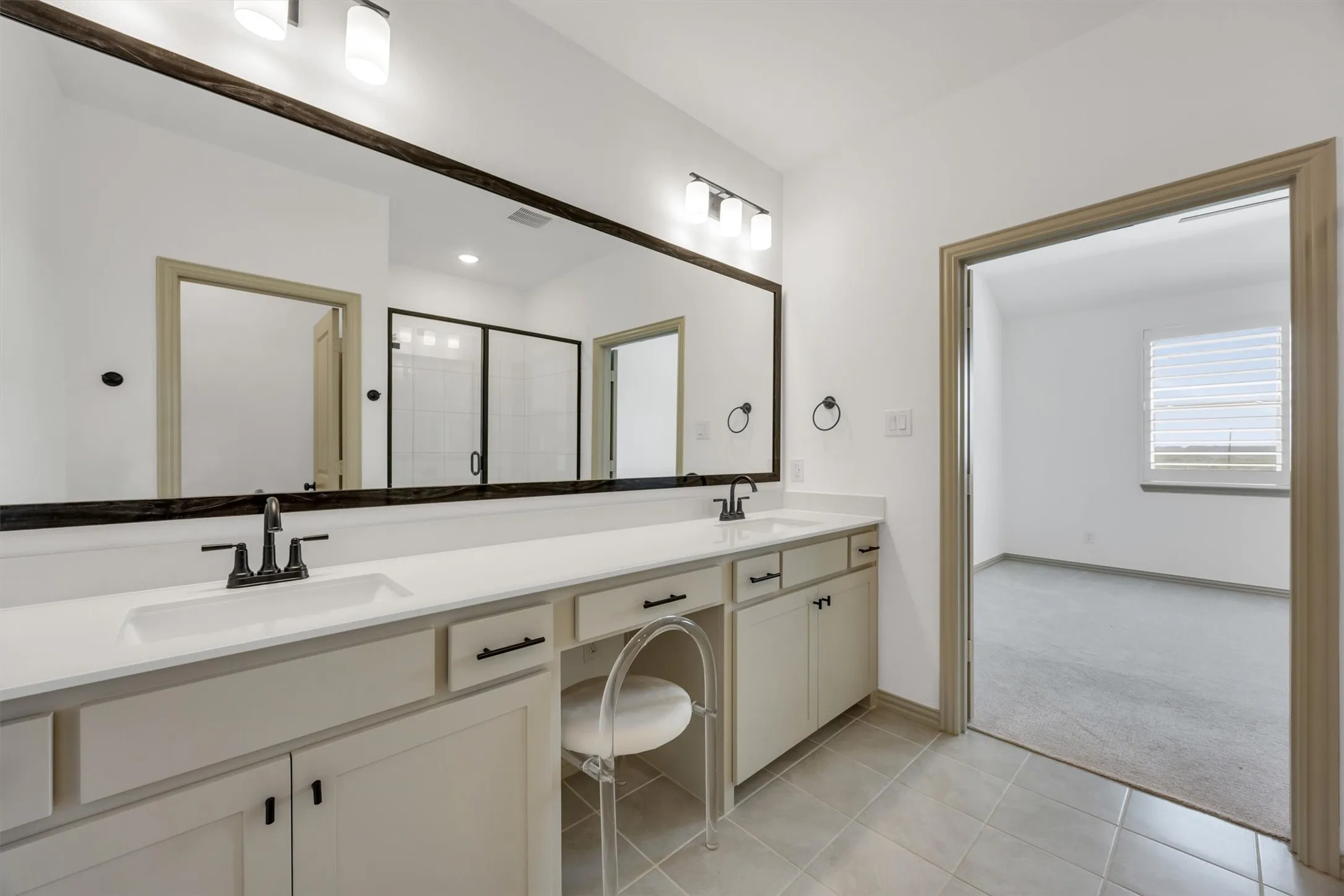 Primary ensuite bathroom with  dual sinks