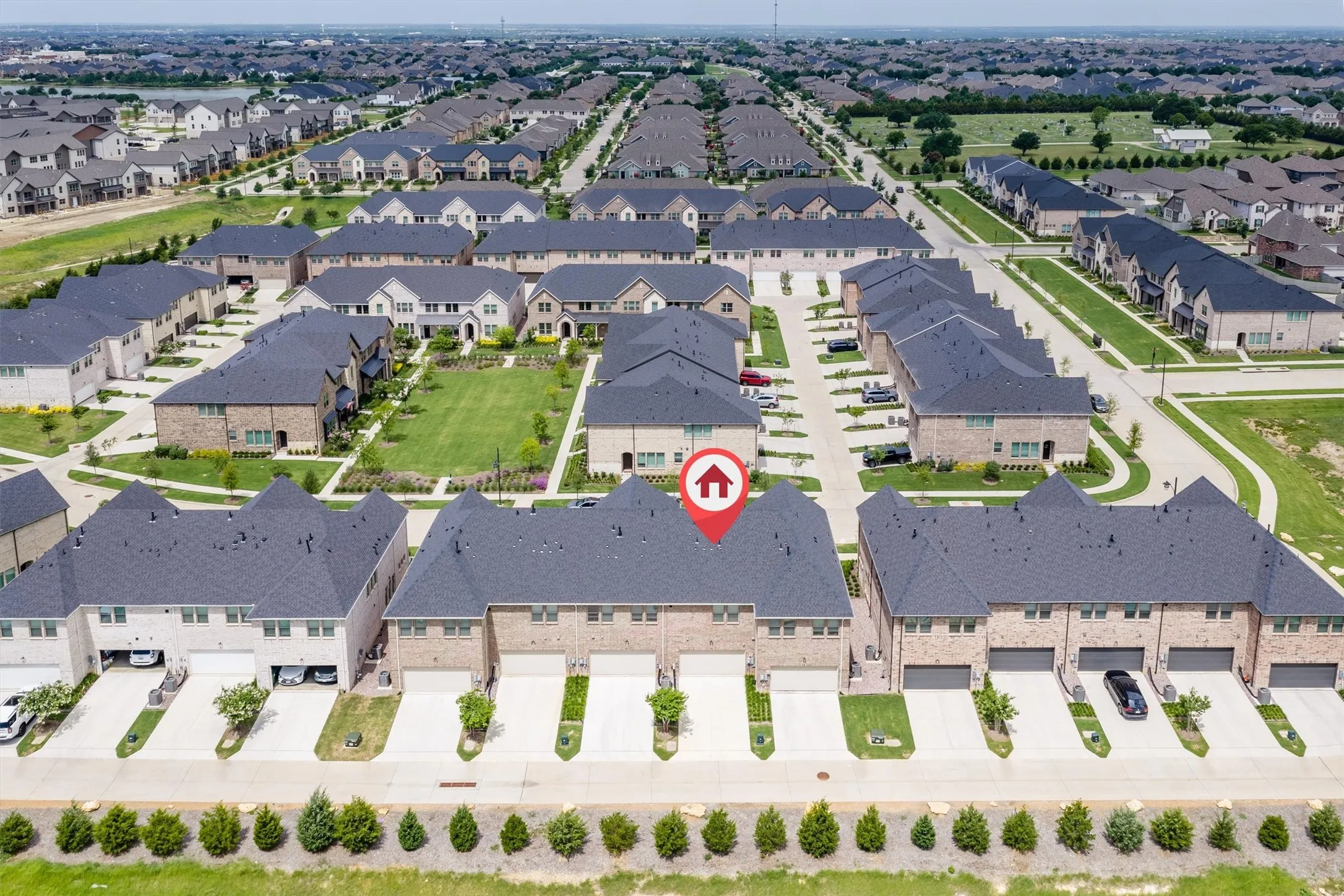 Townhome architecture with brick and siding facades, private driveways, and individual garage access