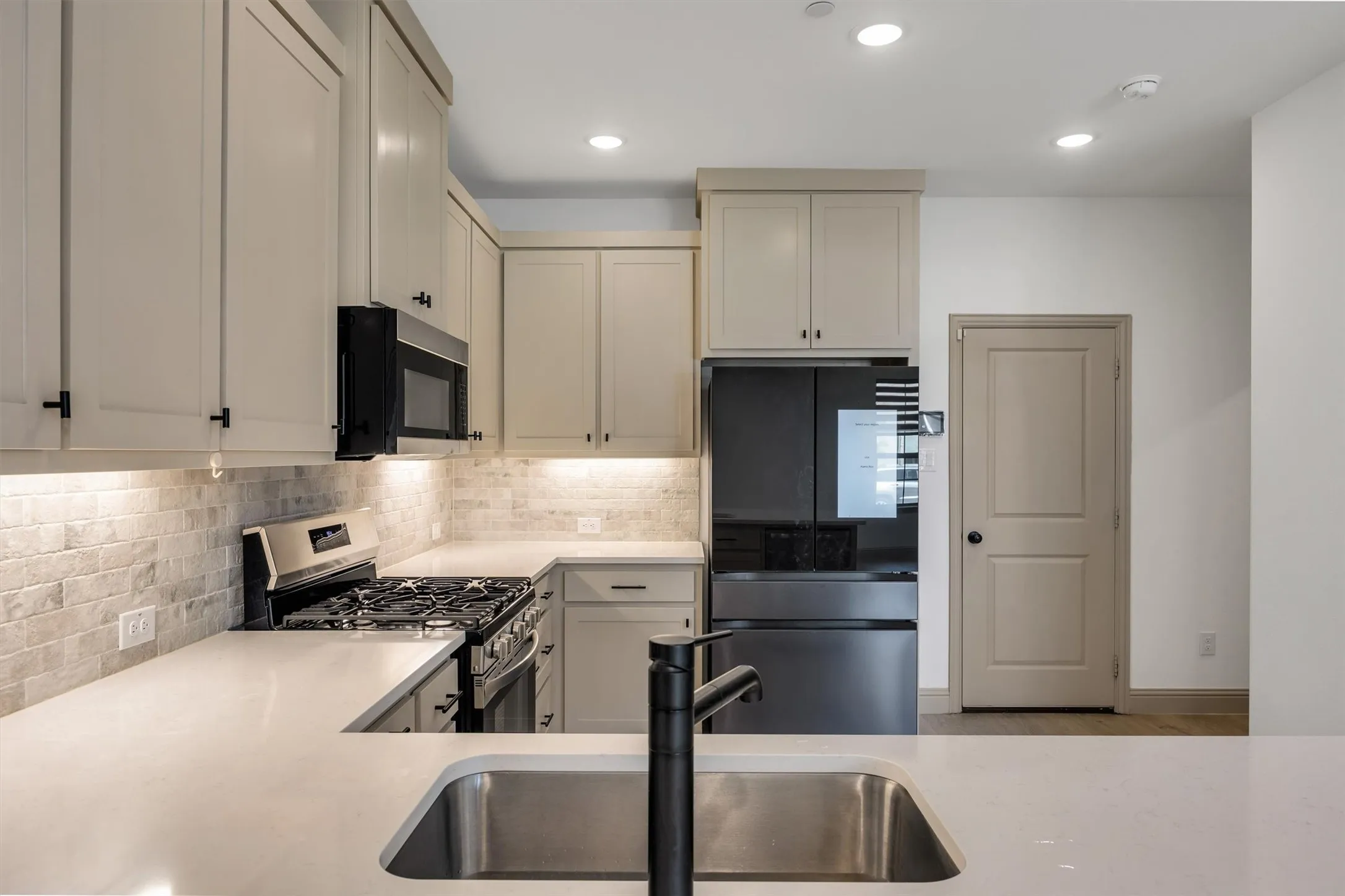 kitchen featuring a full suite of black stainless steel appliances