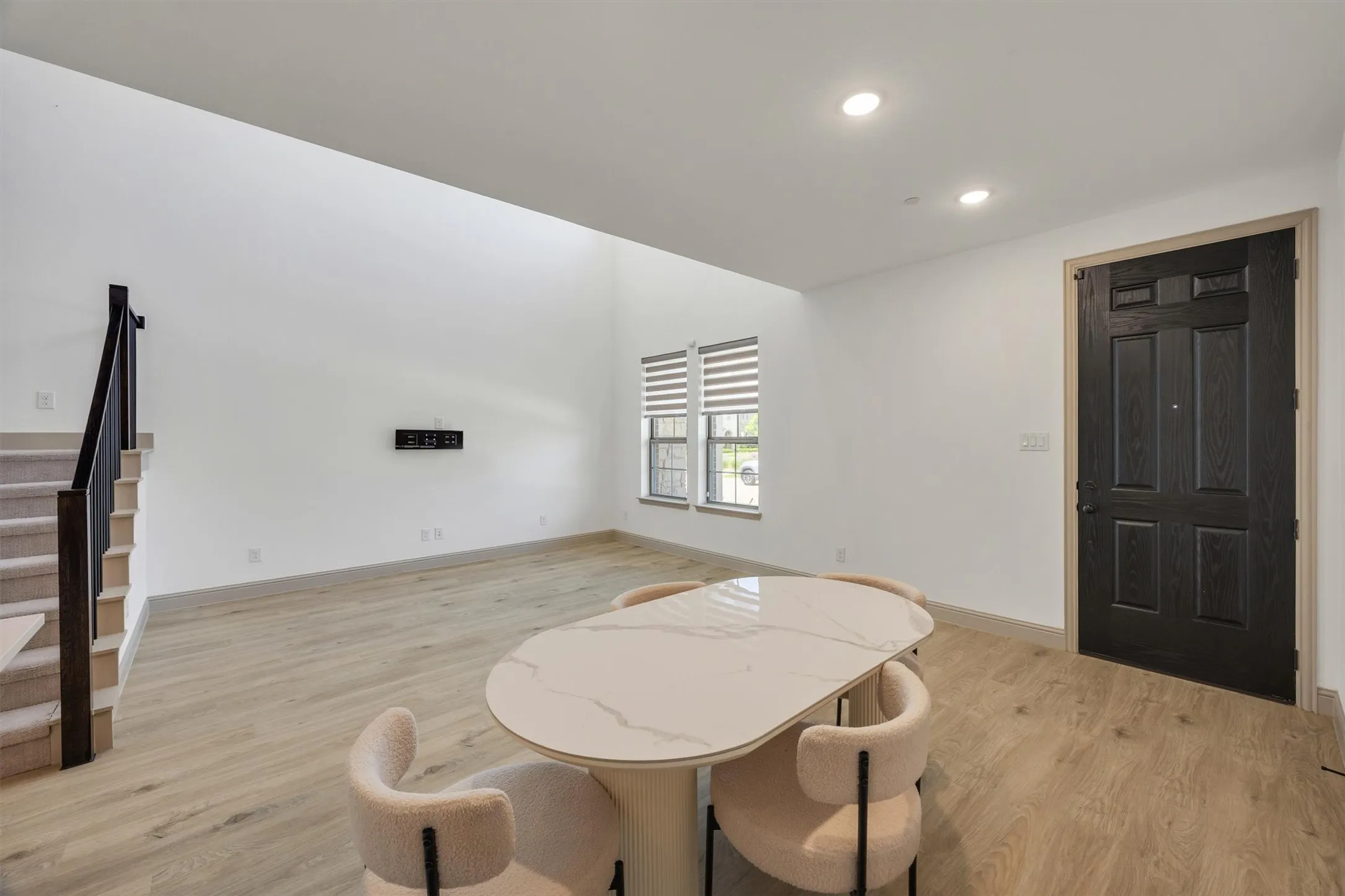 Vaulted ceilings enhance this open-concept room and a paneled entry door