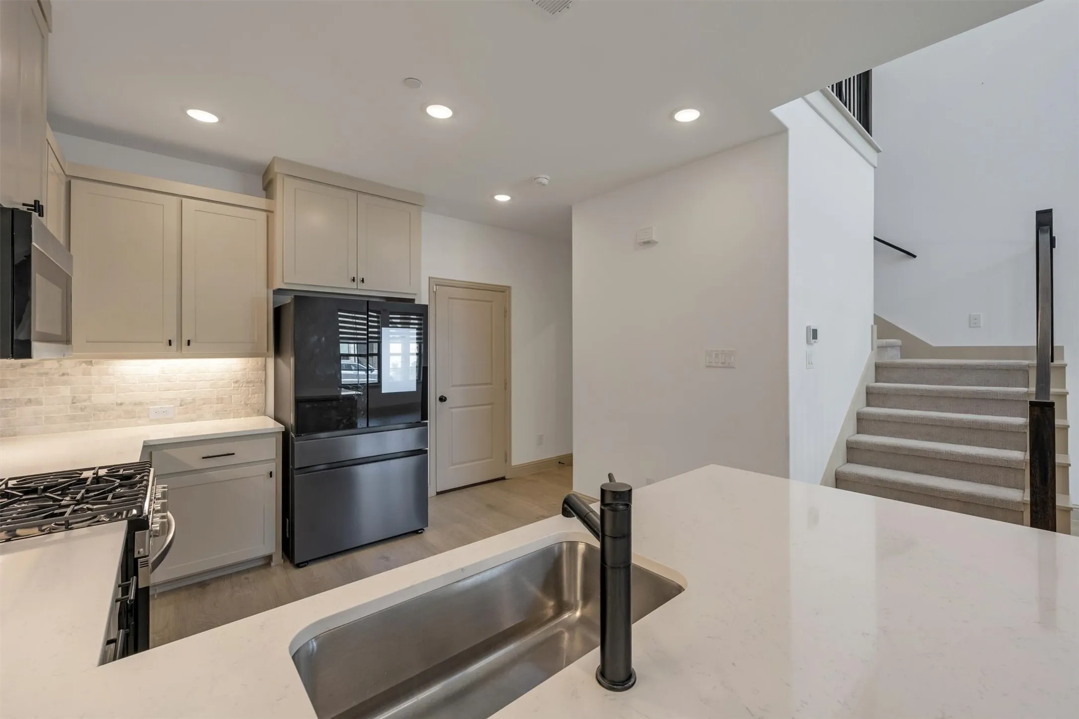 kitchen featuring an integrated sink with a matte black faucet