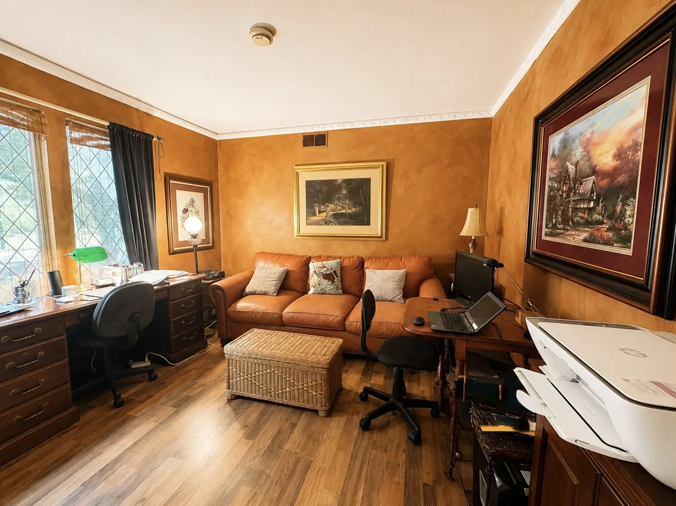 Wood-finish flooring, crown molding, leaded glass window, and textured wall finish