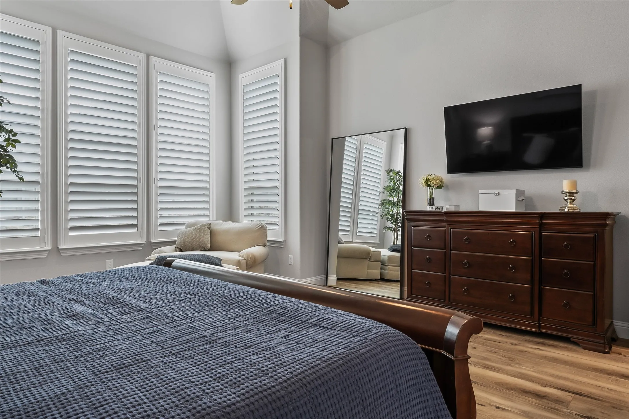Bedroom featuring light hardwood / wood-style floors, ceiling fan, and lofted ceiling