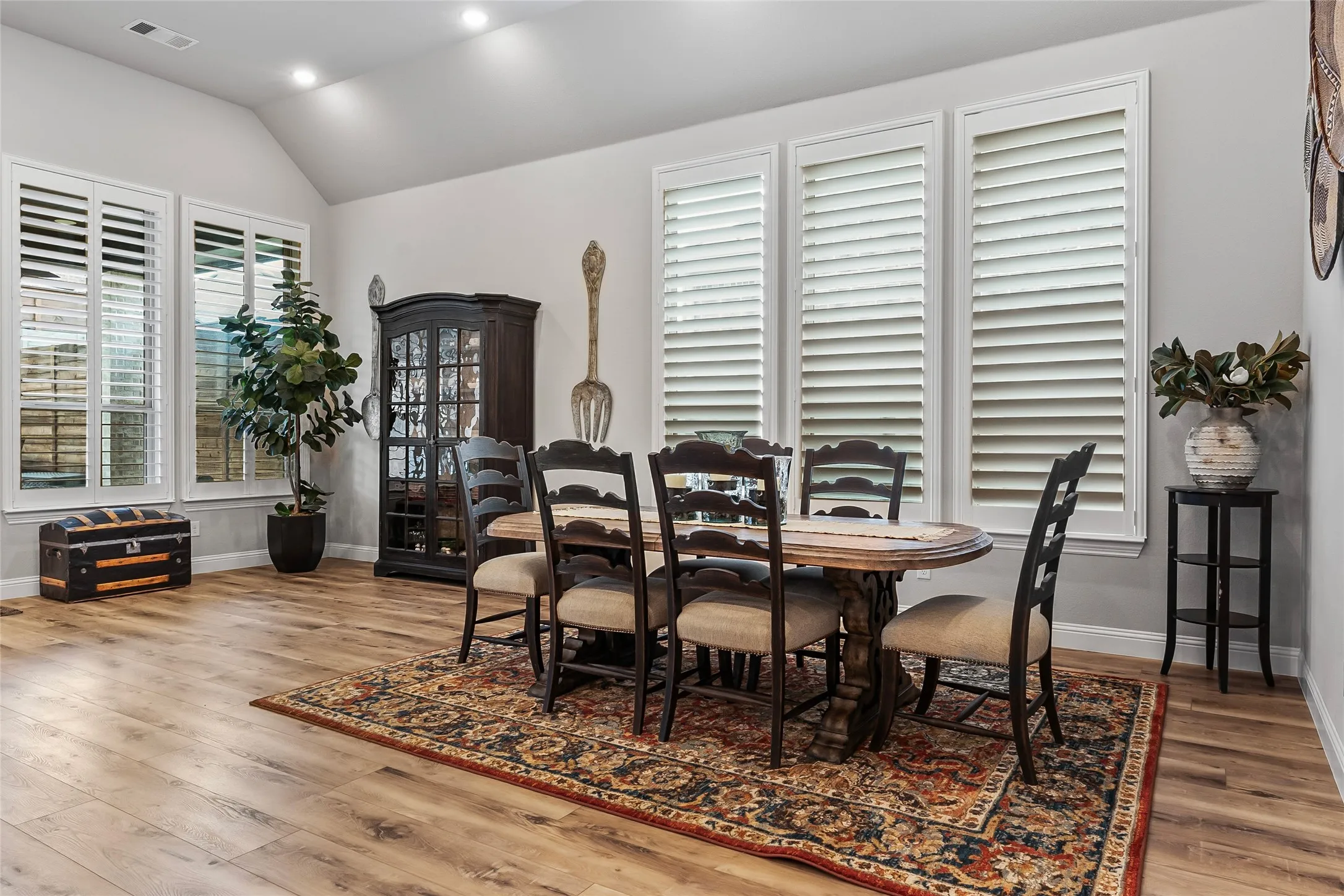 Dining area with hardwood / wood-style flooring and lofted ceiling