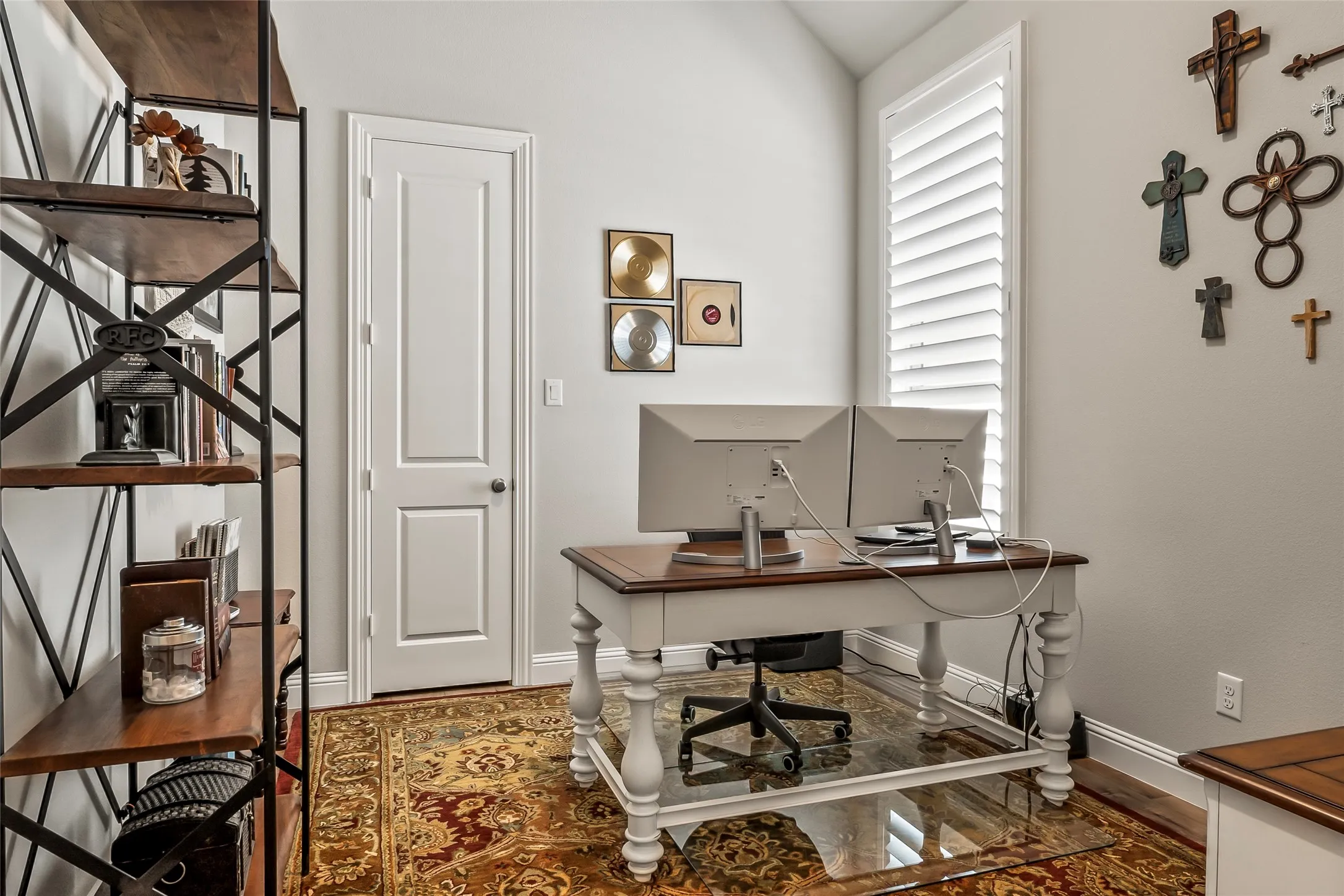 Office space with hardwood / wood-style floors and lofted ceiling