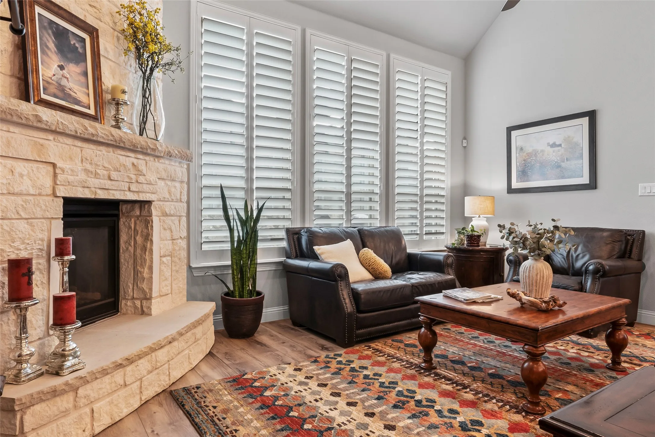 Living room with a fireplace, lofted ceiling, and hardwood / wood-style flooring