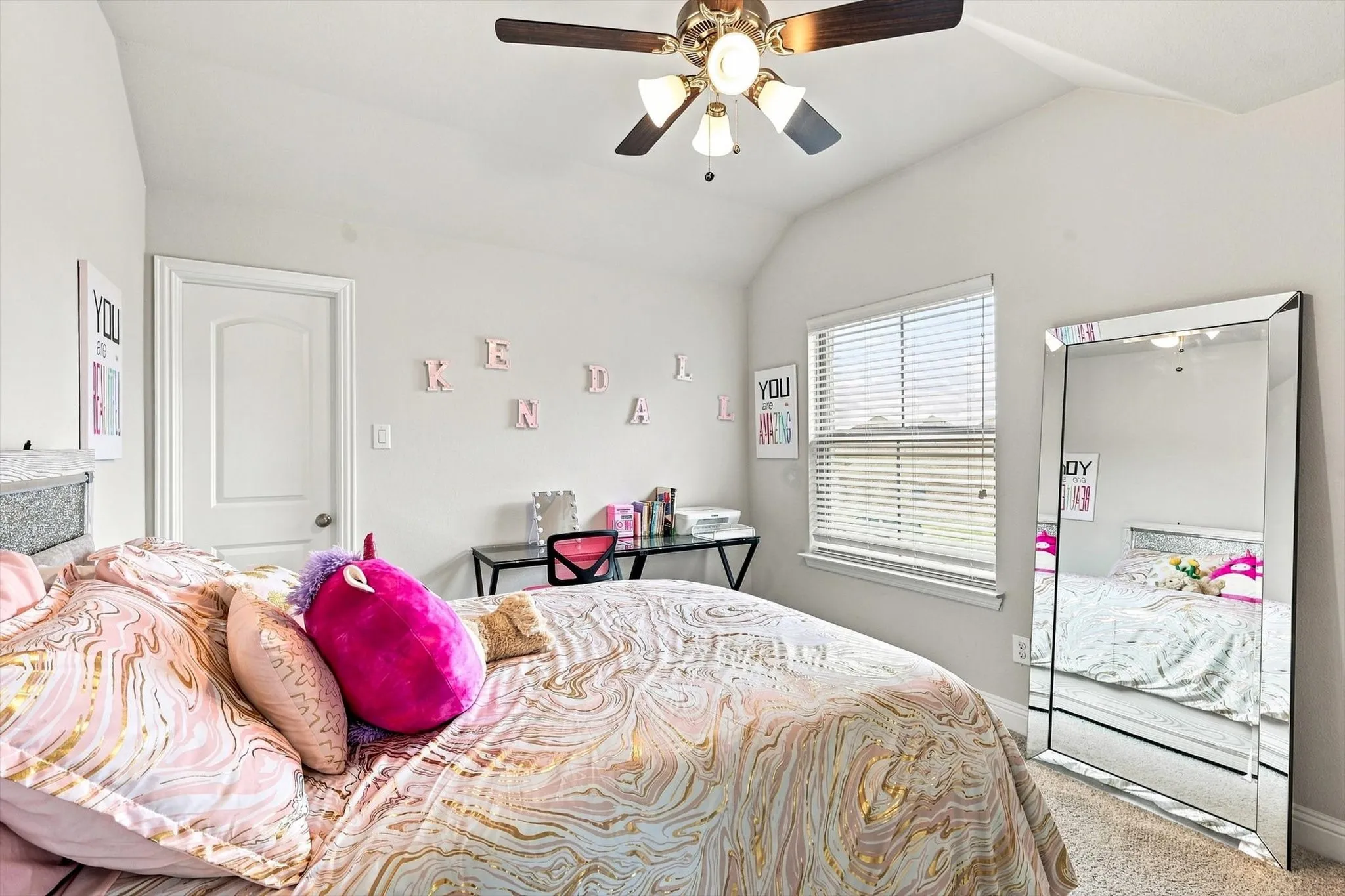 Vaulted ceiling, ceiling fan with integrated lighting, window with horizontal blinds, neutral wall paint, and carpeted flooring