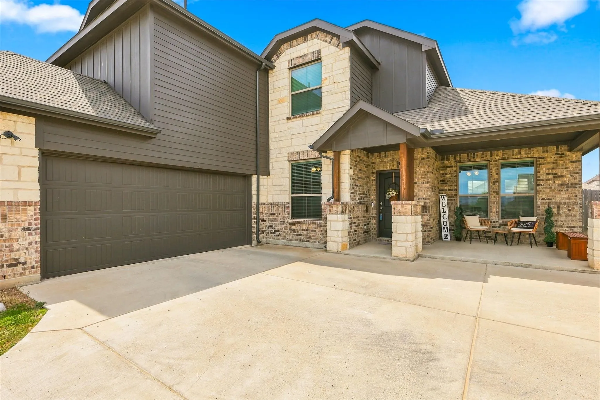 Brick and stone facade with dark siding accents