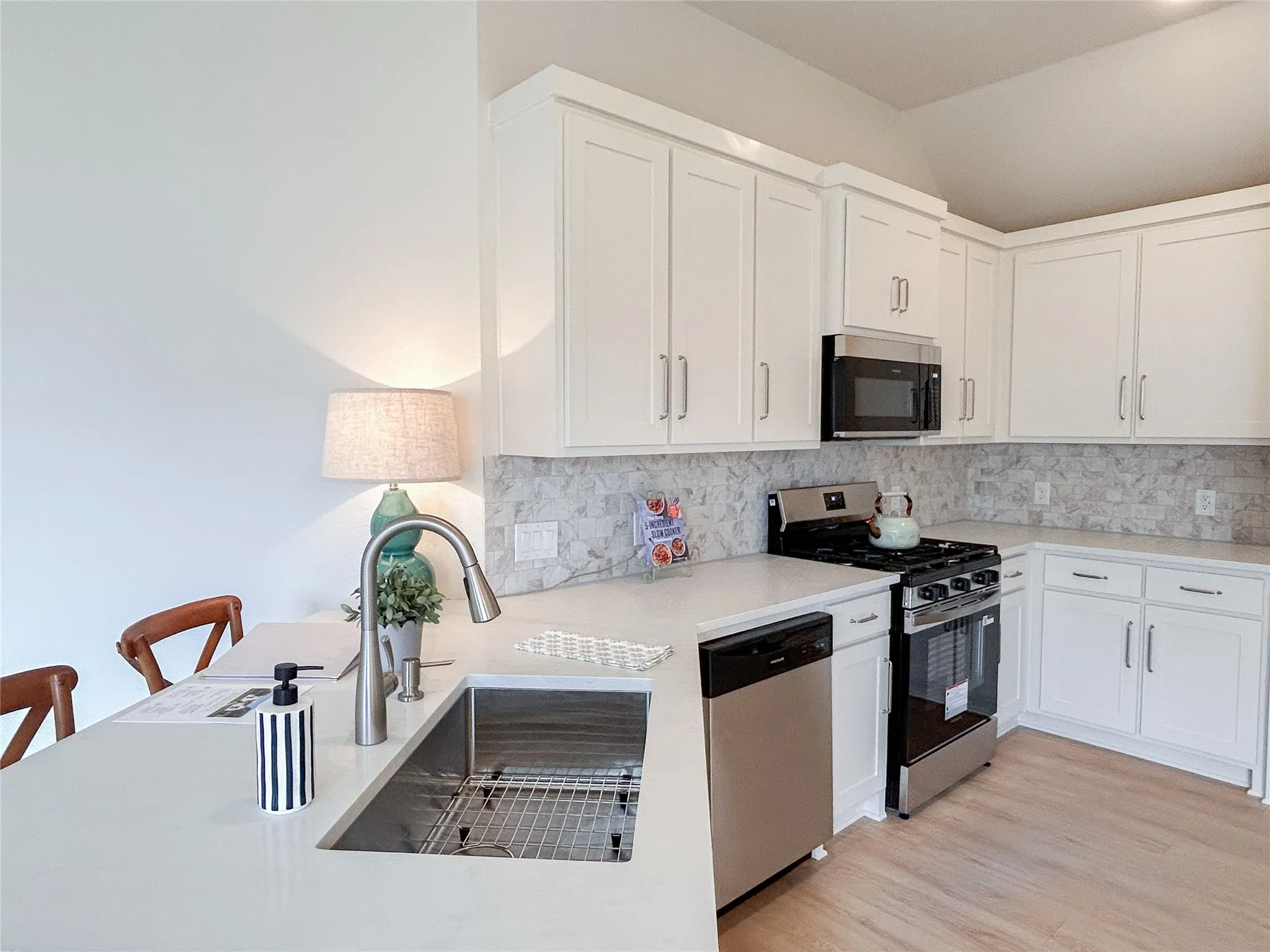 breakfast bar, perfect for a quick meal, large stainless steal sink, Moen faucet, gas stove