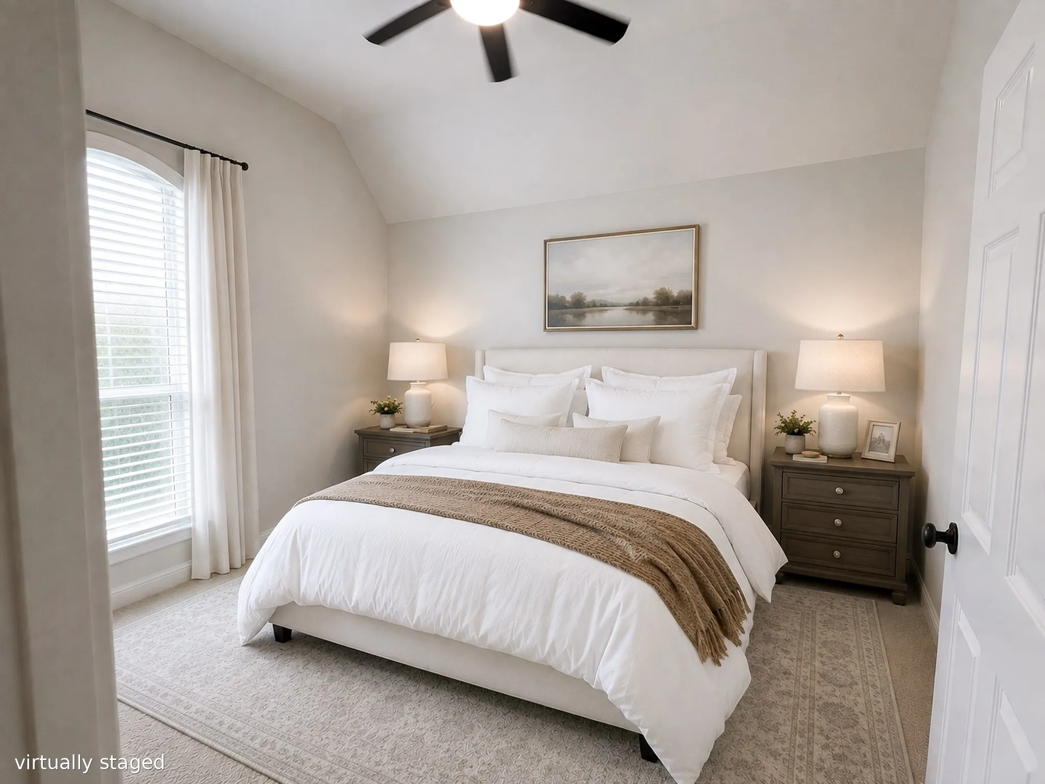 Cozy secondary bedroom with vaulted ceiling, large window, plush carpeting, and abundant natural light.