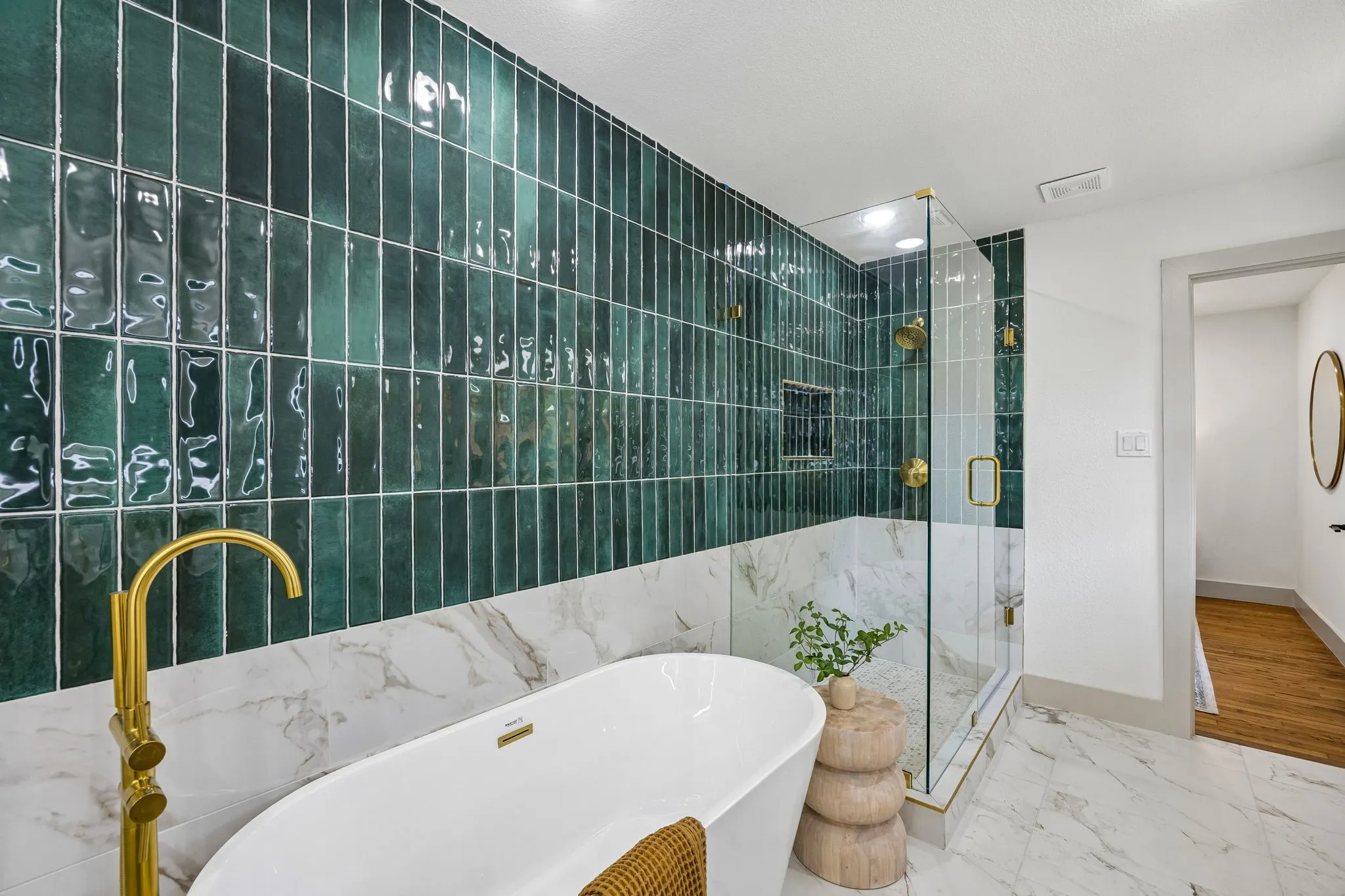Freestanding bathtub with a gold-finish floor-mounted faucet