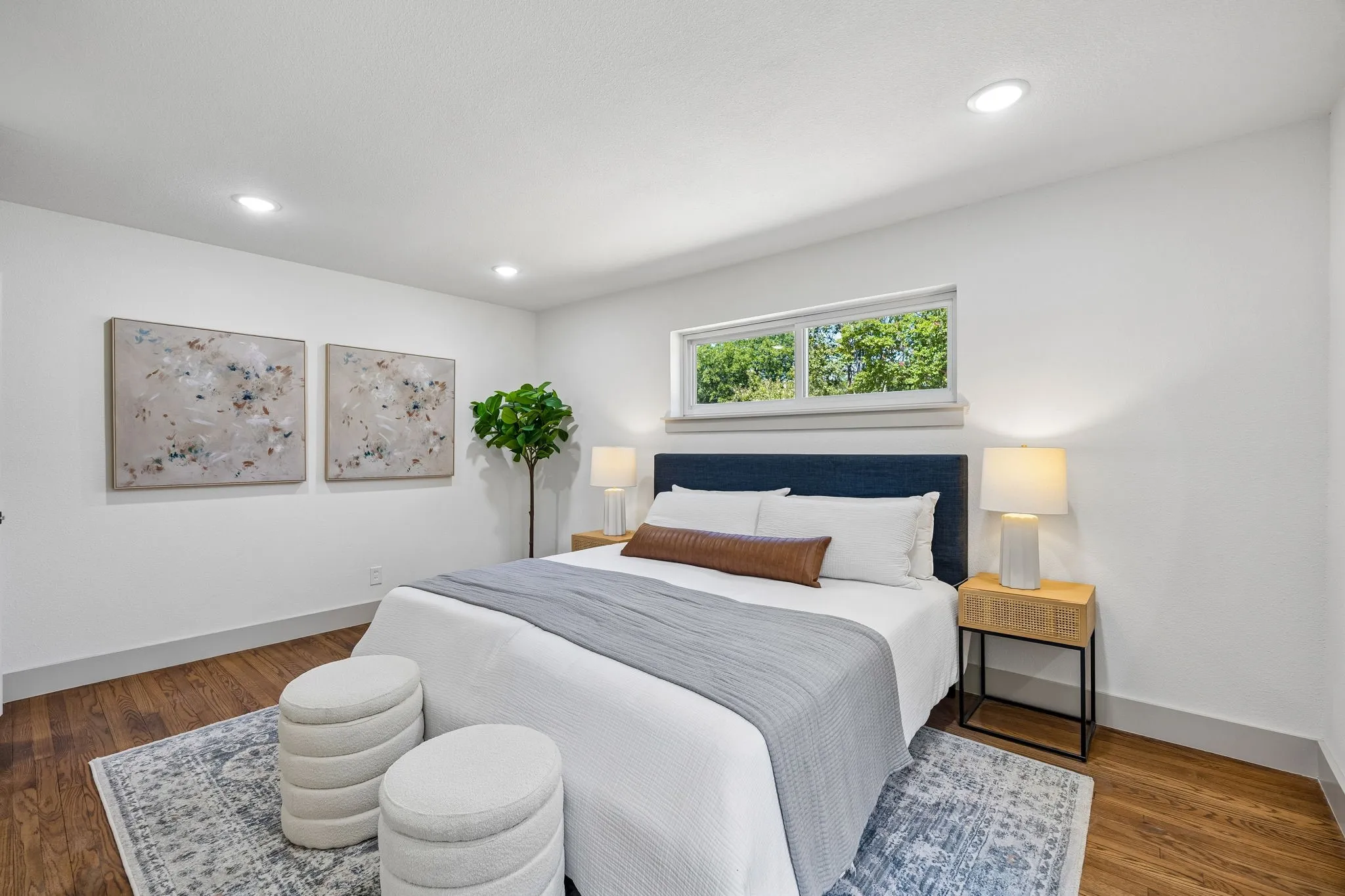 Recessed lighting, wood-finish flooring, and a horizontal window