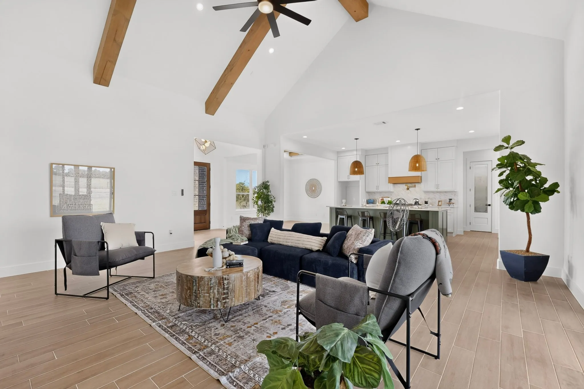 Vaulted ceiling with exposed wood beams and recessed lighting