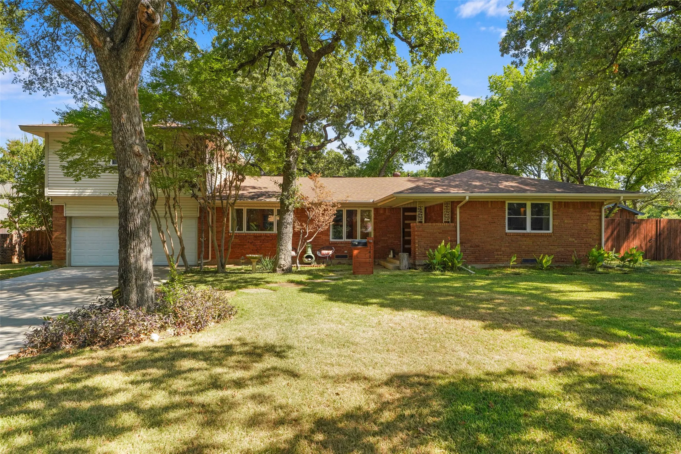 Daytime exterior beneath mature trees