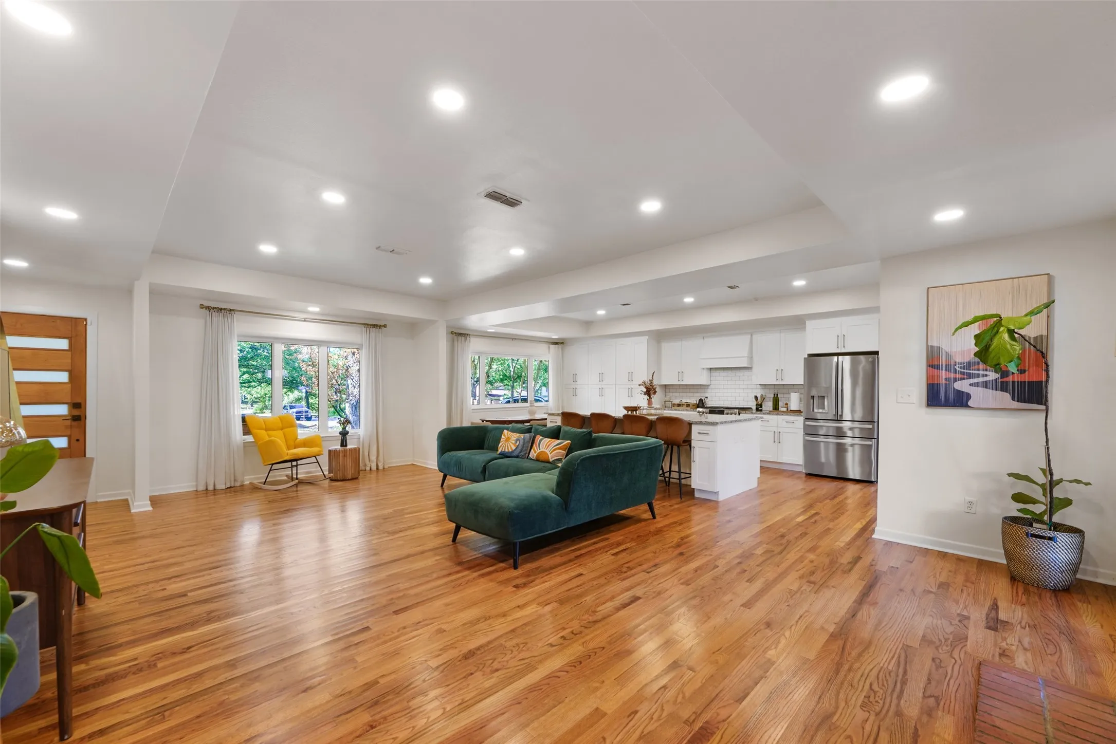 Light-filled open living area with hardwood floors