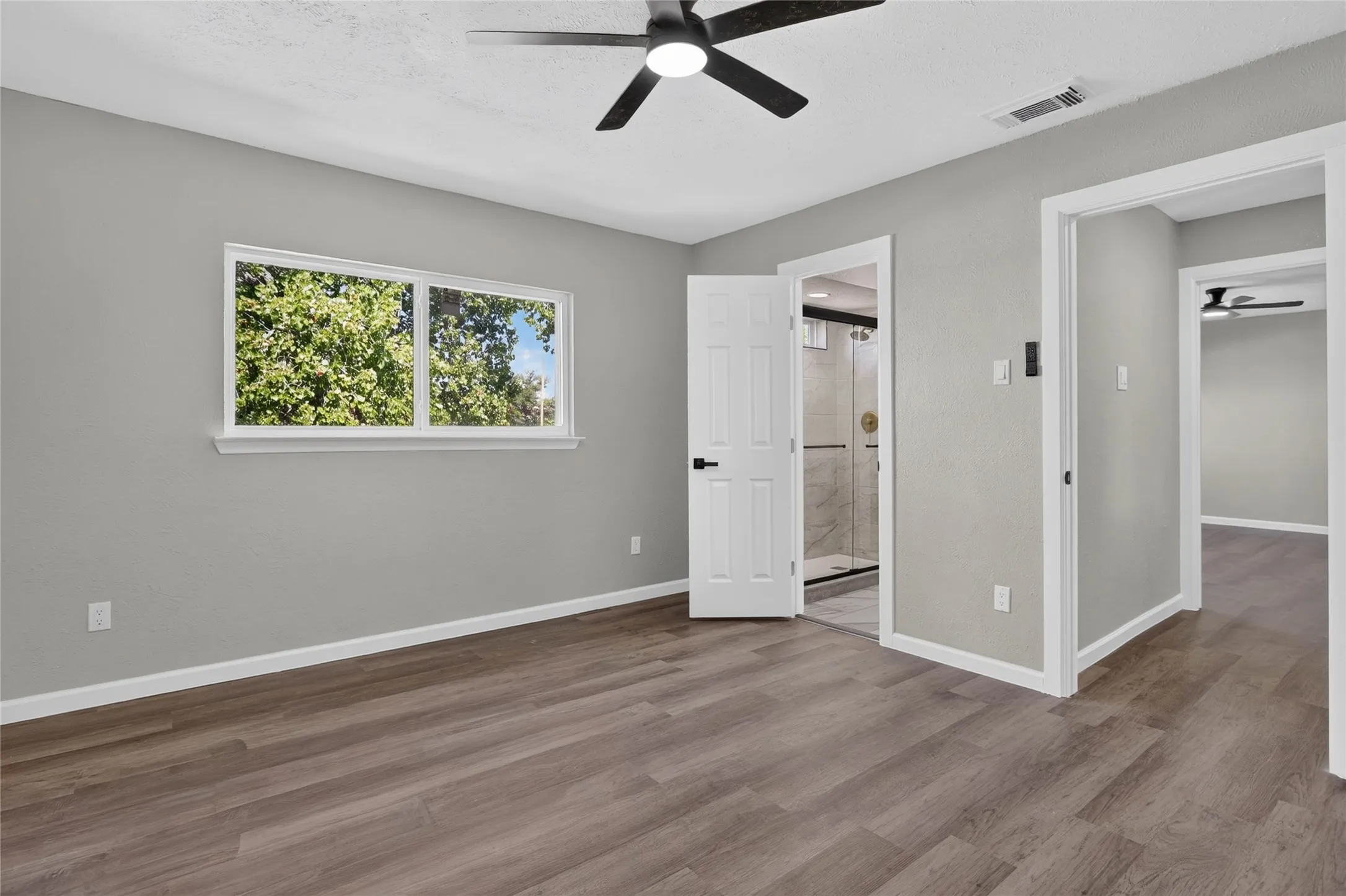 Wood-finish flooring, recessed window, and a ceiling fan